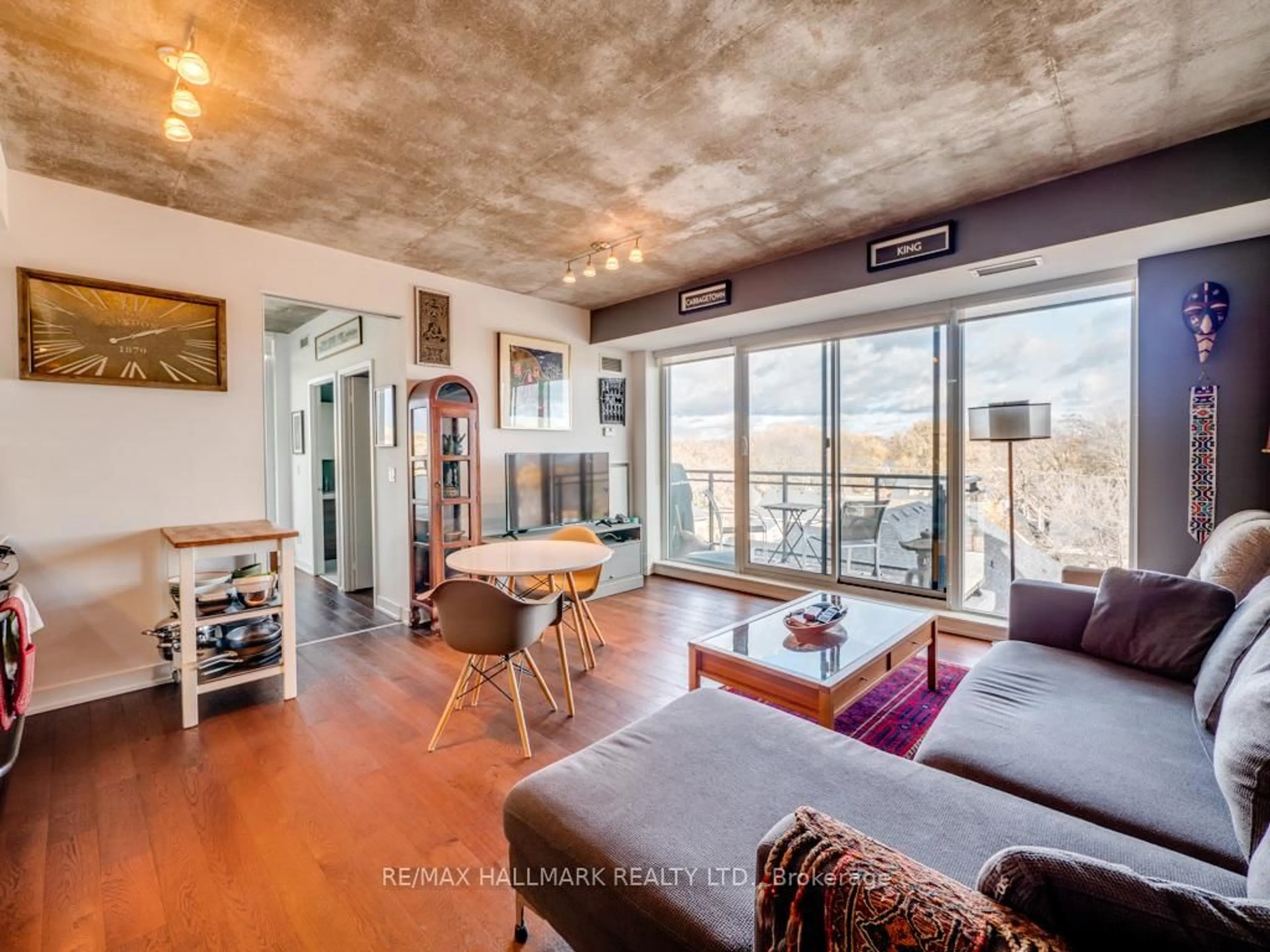 Living room with furniture, cement floor for 1238 Dundas St #602, Toronto Ontario M4M 0C6