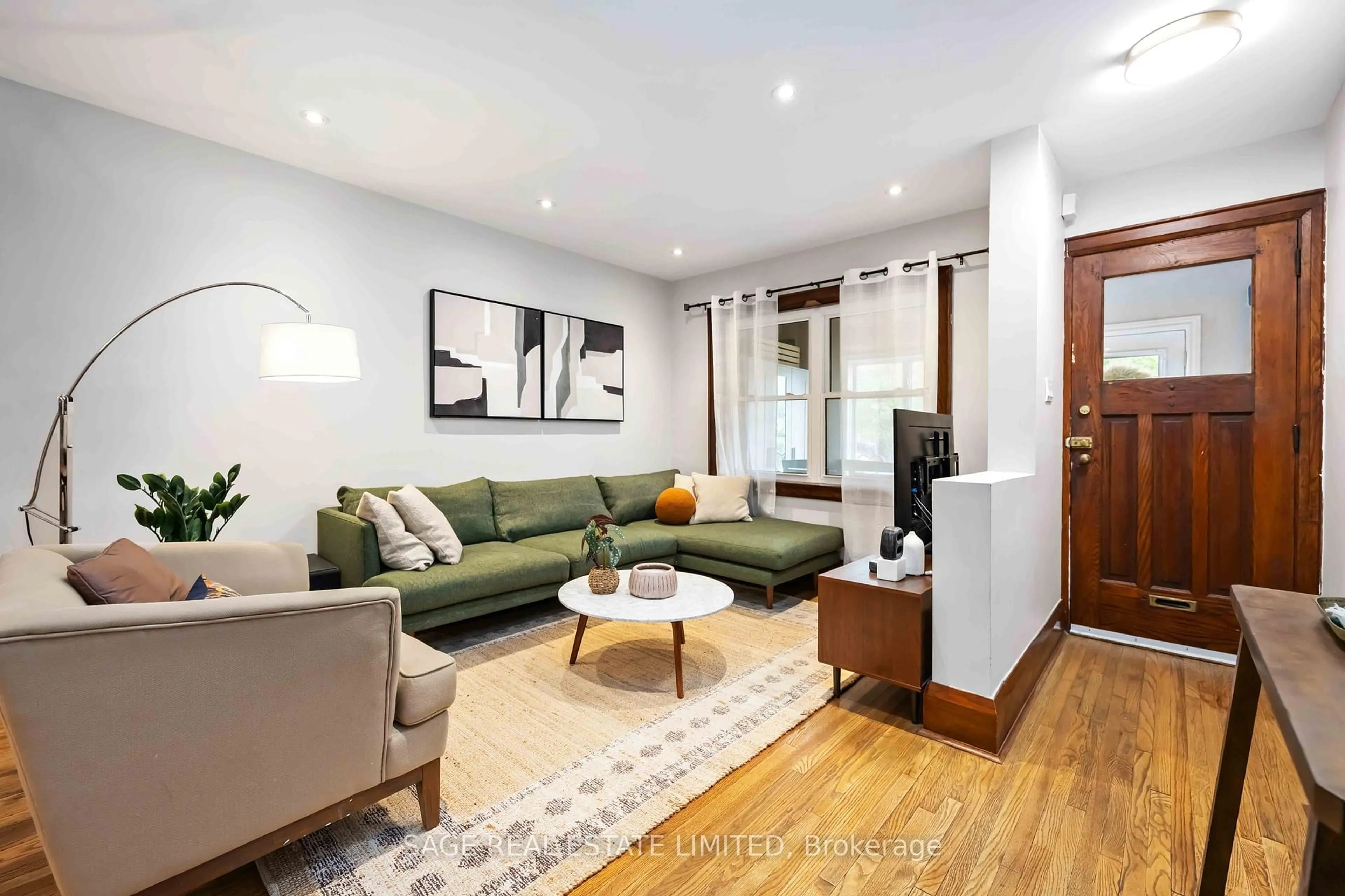 Living room with furniture, wood/laminate floor for 552 Victoria Park Ave, Toronto Ontario M4E 3T5