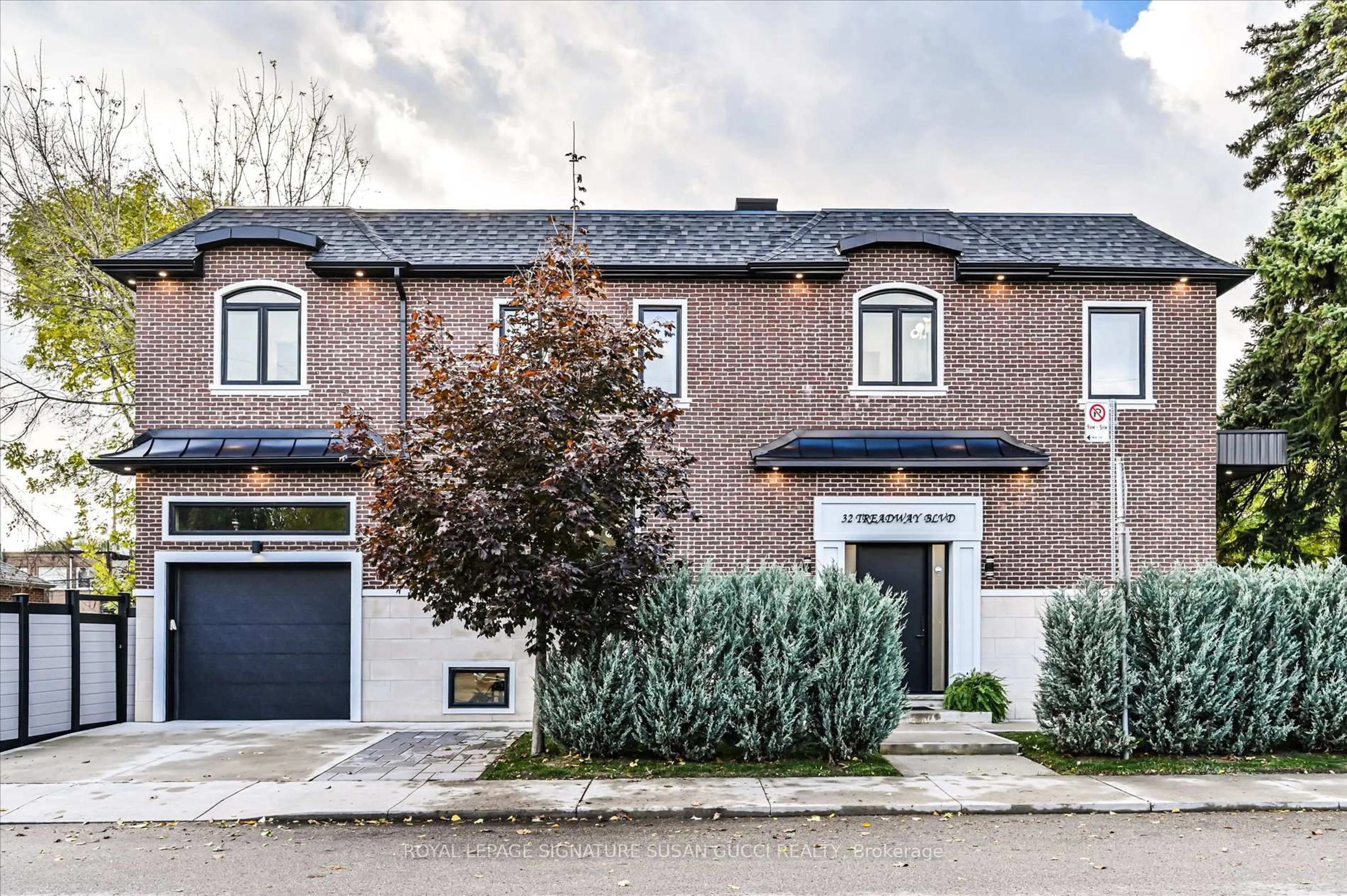 Home with brick exterior material, street for 32 Treadway Blvd, Toronto Ontario M4C 2Z7