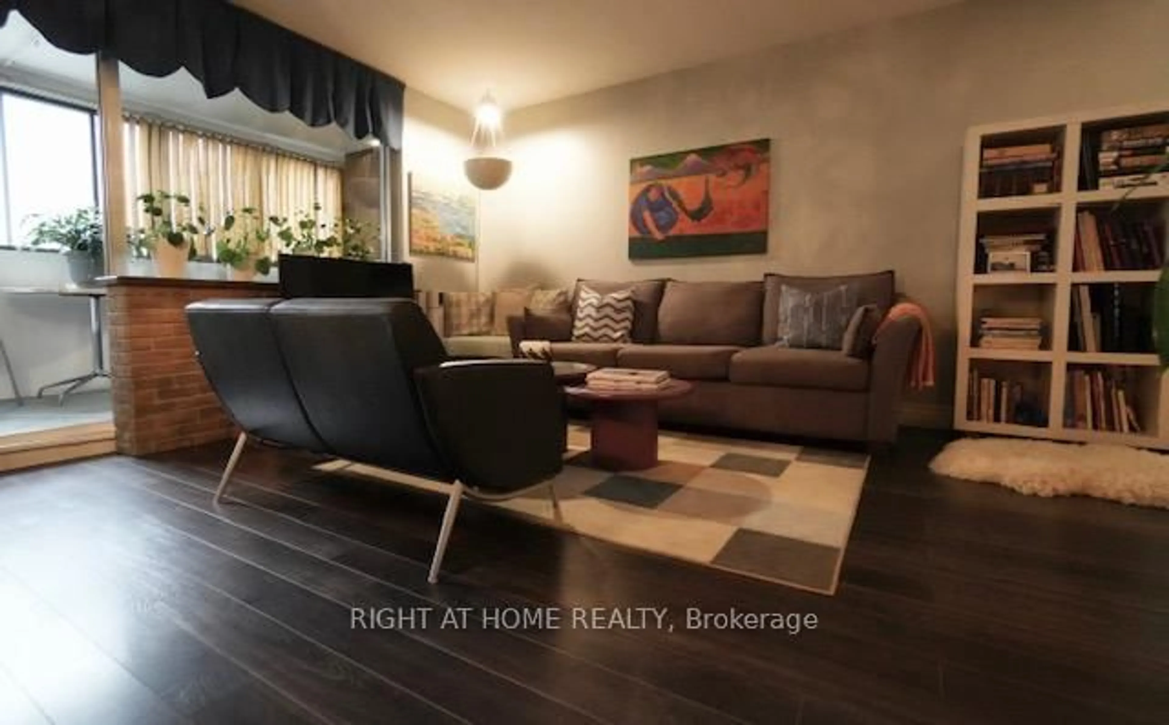 Living room with furniture, wood/laminate floor for 5 Massey Sq #411, Toronto Ontario M4C 5L6