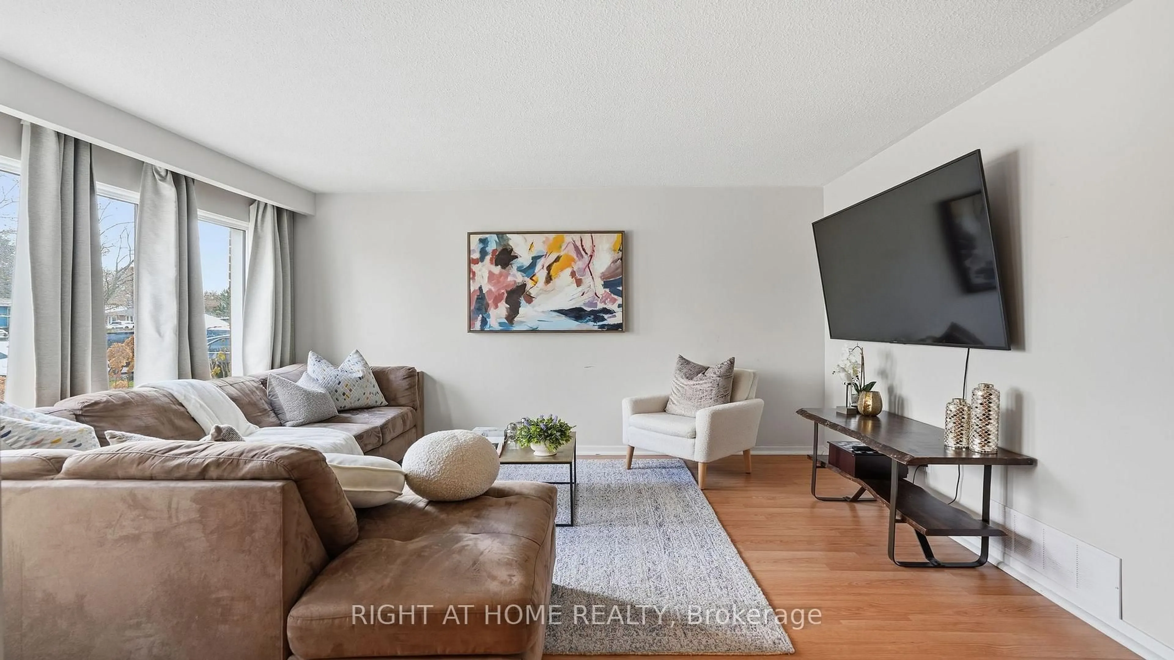 Living room with furniture, wood/laminate floor for 408 Camelot Crt, Oshawa Ontario L1G 6P7