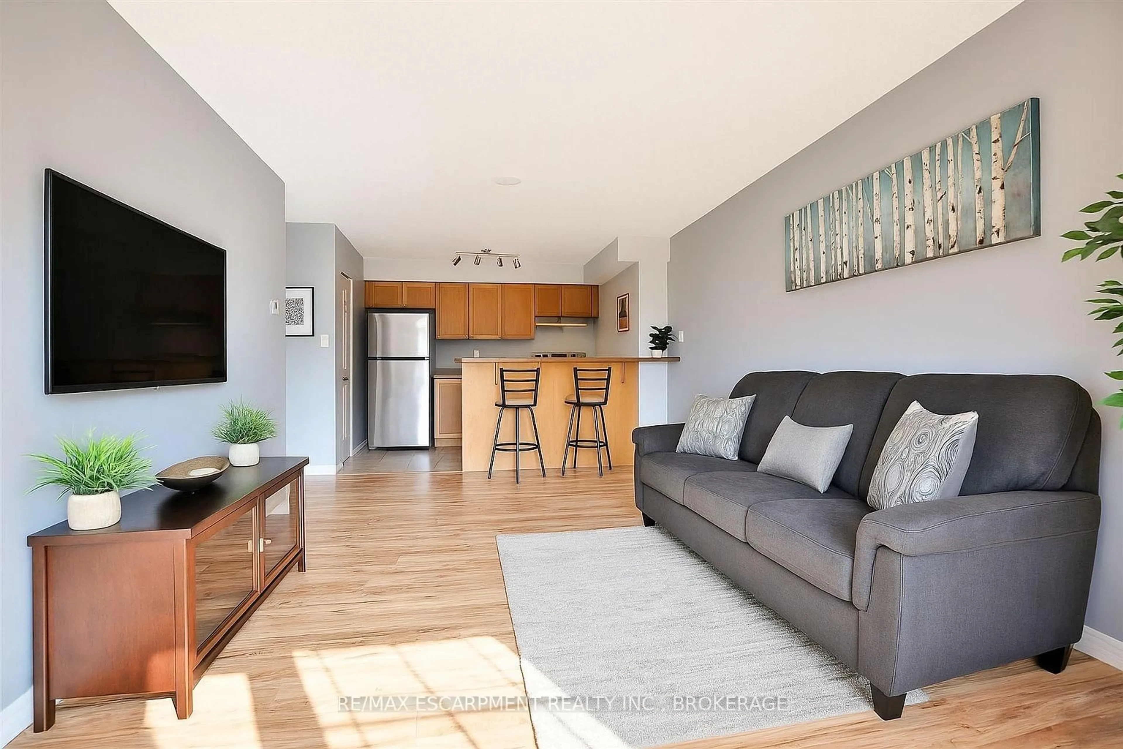 Living room with furniture, wood/laminate floor for 75 Shipway Ave #209, Clarington Ontario L1B 0B6