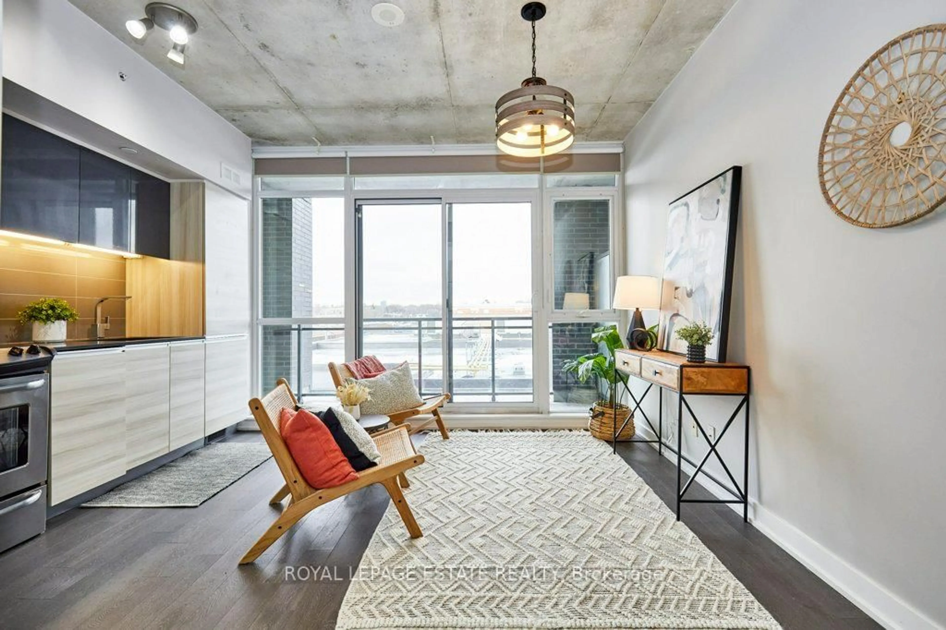 Living room with furniture, cement floor for 1190 Dundas St #525, Toronto Ontario M4M 0C5