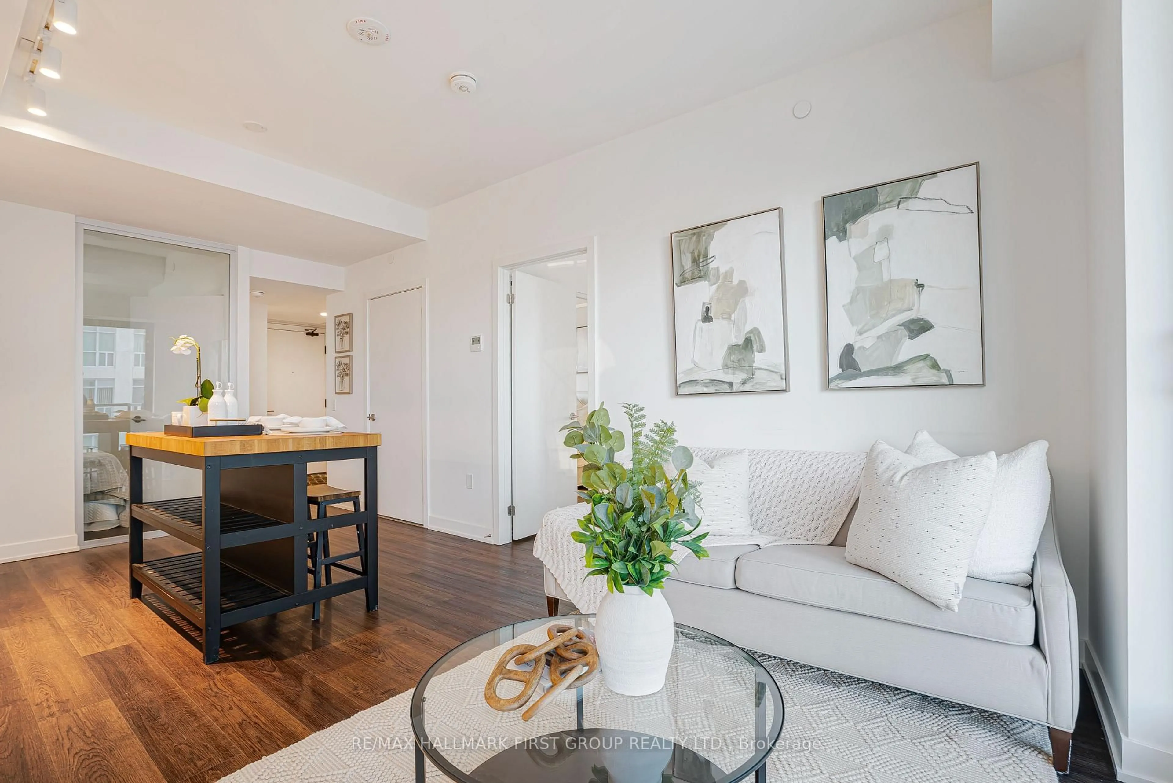 Living room with furniture, wood/laminate floor for 1604 Charles St #316, Whitby Ontario L1N 0P2