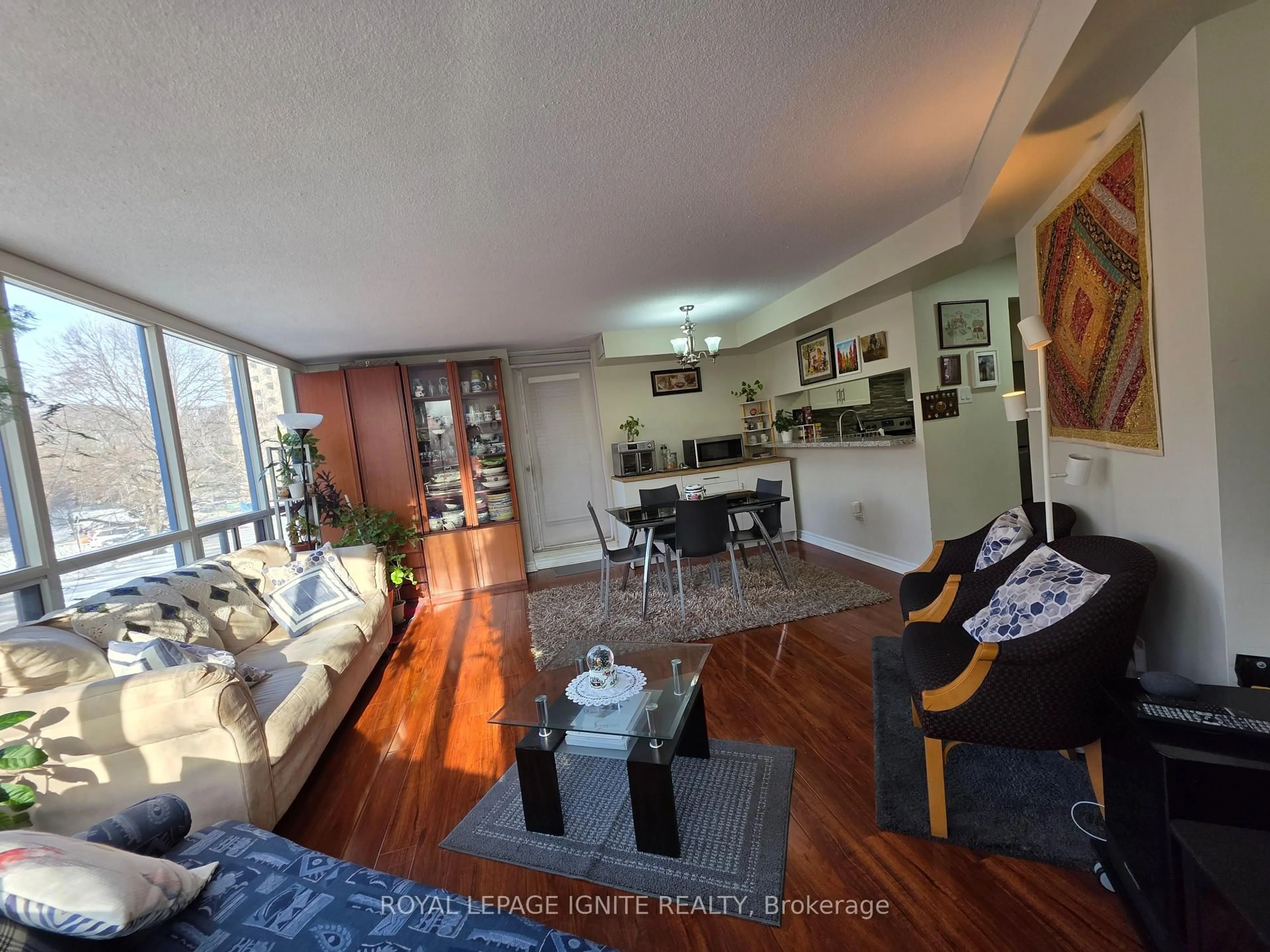 Living room with furniture, wood/laminate floor for 3050 Ellesmere Rd #312, Toronto Ontario M1E 5E6