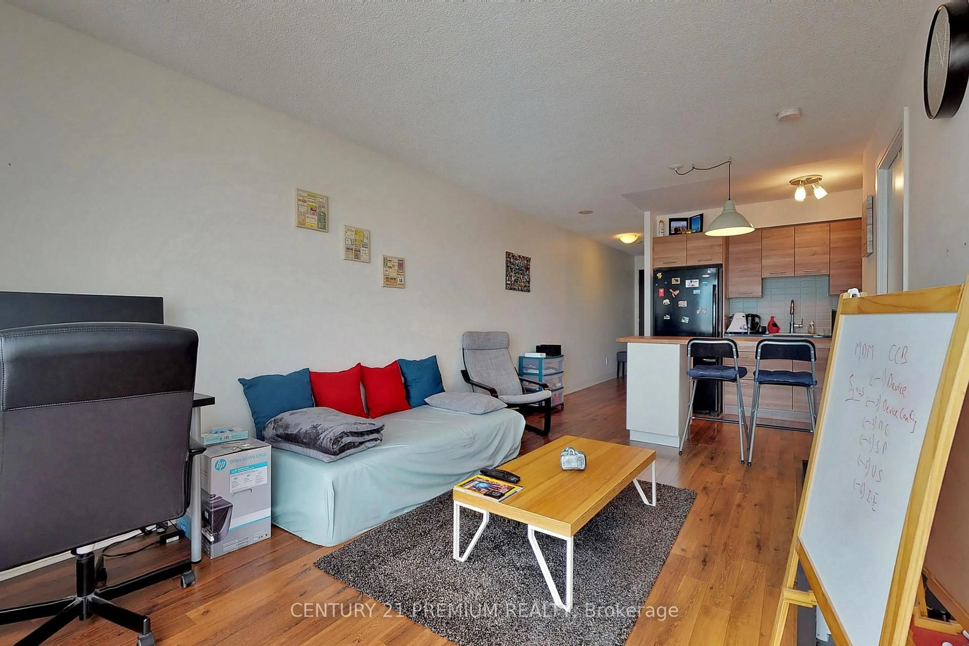 Living room with furniture, wood/laminate floor for 135 Village Green Sq #1015, Toronto Ontario M1S 0L7