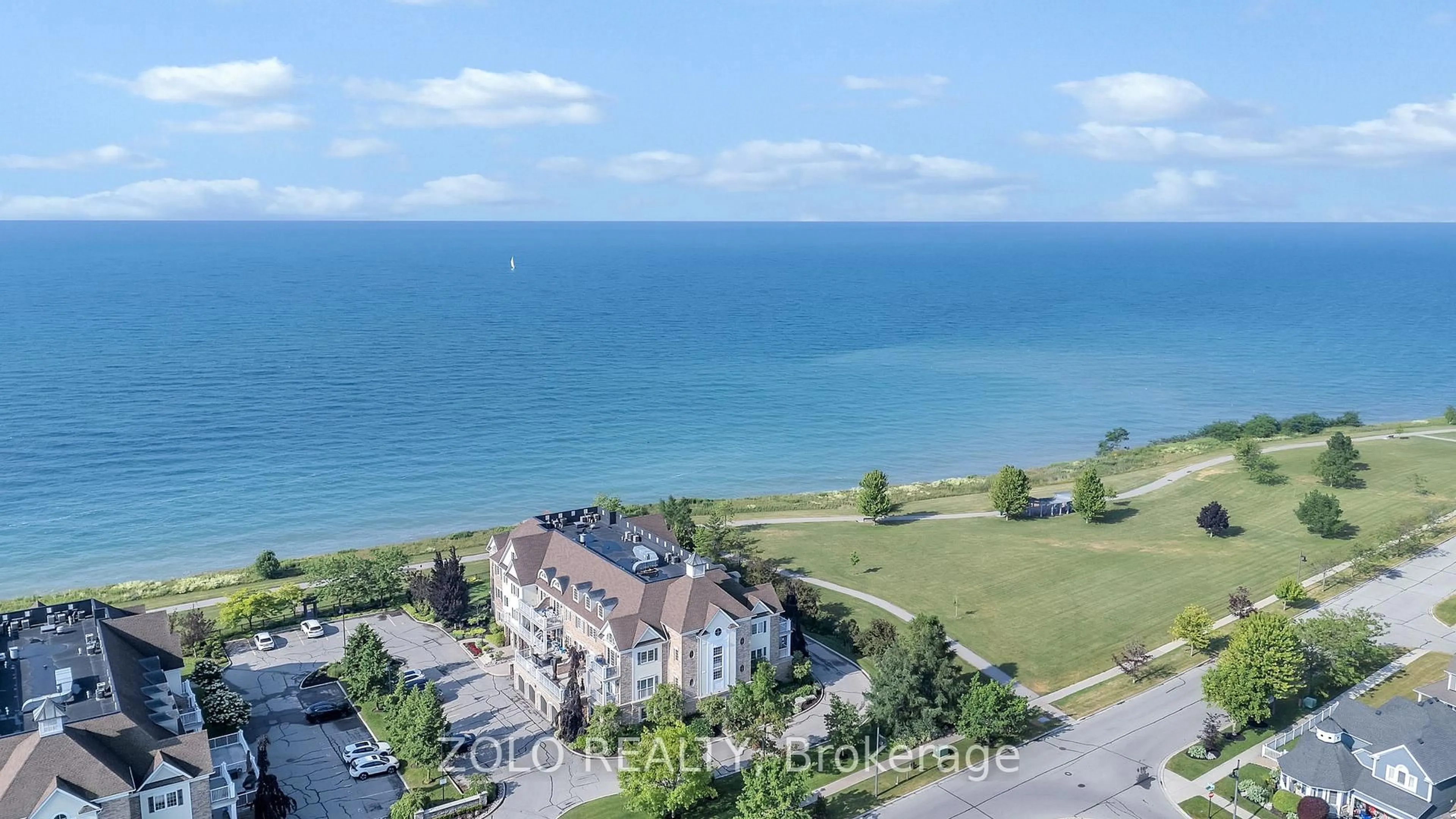 A pic from outside/outdoor area/front of a property/back of a property/a pic from drone, water/lake/river/ocean view for 395 Lakebreeze Dr #301, Clarington Ontario L1B 0A5
