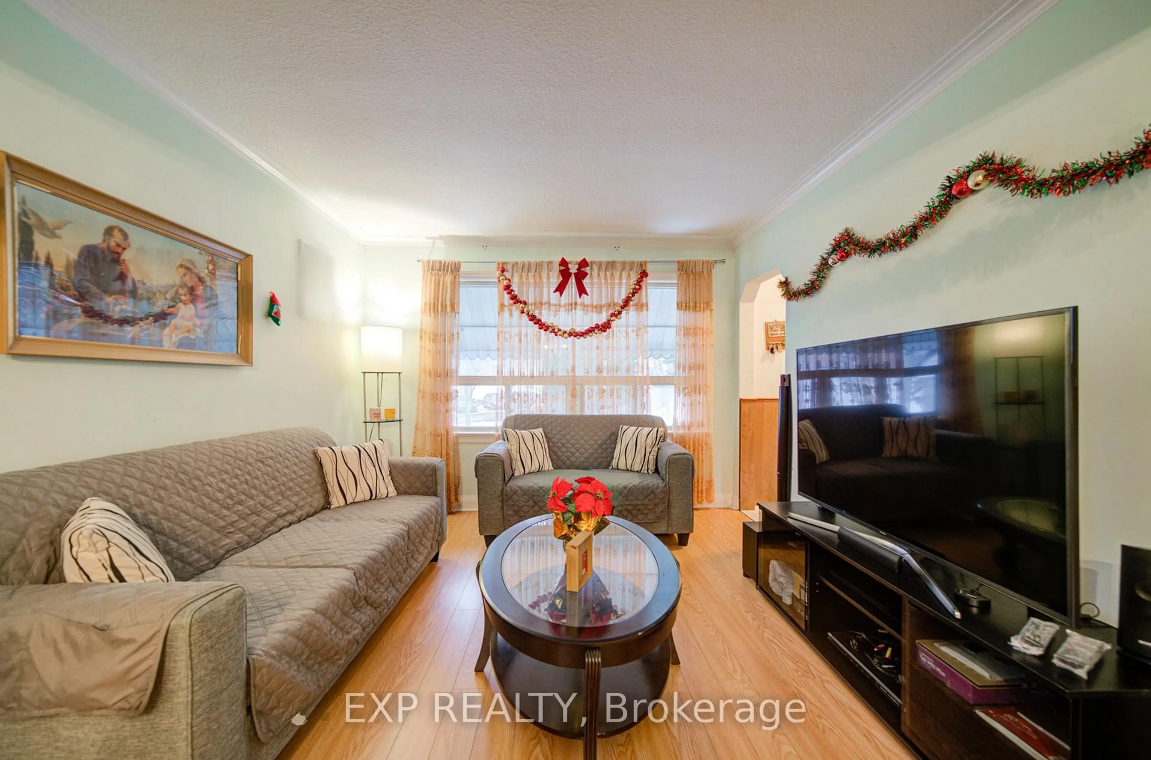Living room with furniture, wood/laminate floor for 63 Midland Ave, Toronto Ontario M1N 3Z8