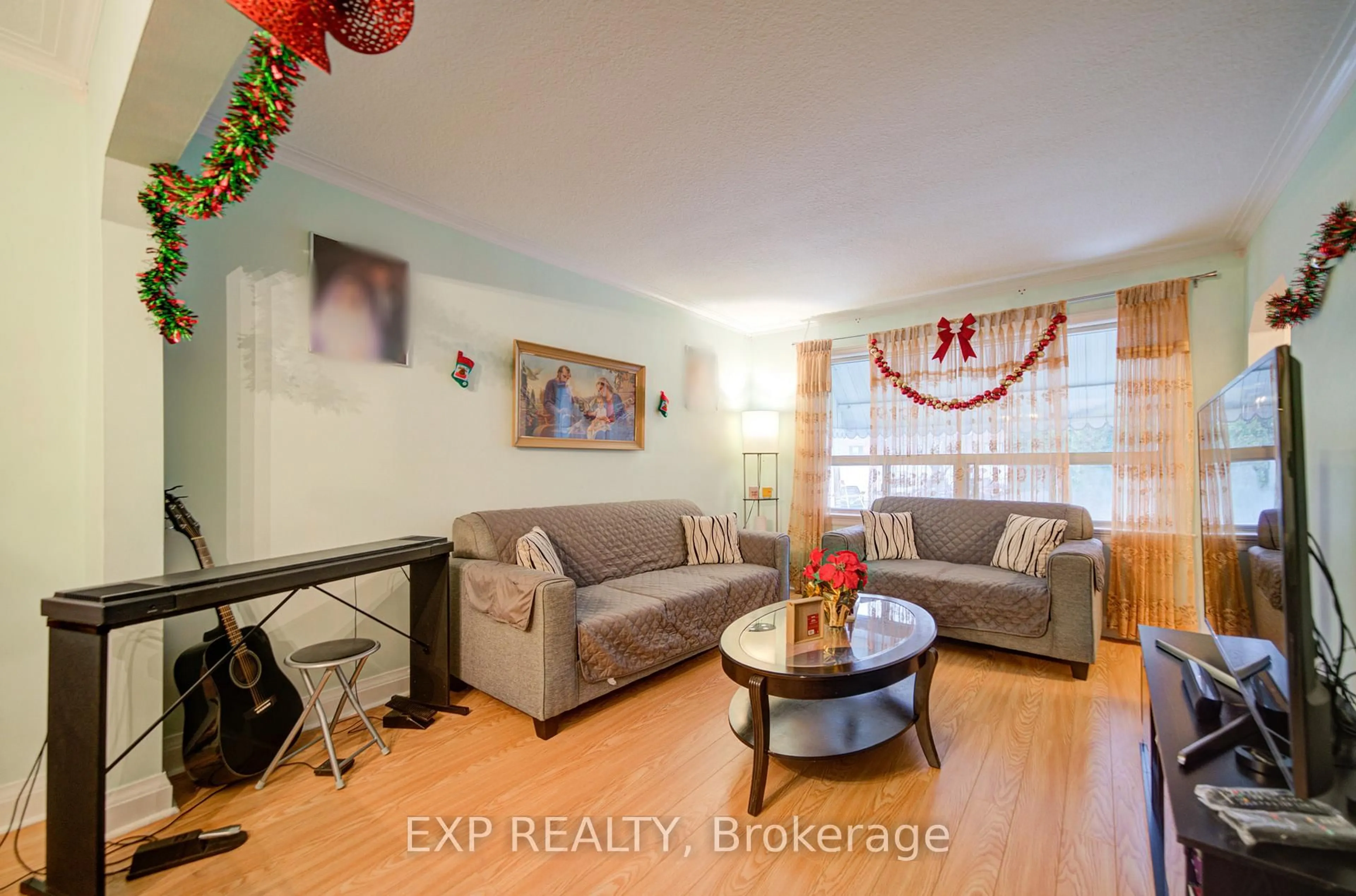 Living room with furniture, wood/laminate floor for 63 Midland Ave, Toronto Ontario M1N 3Z8