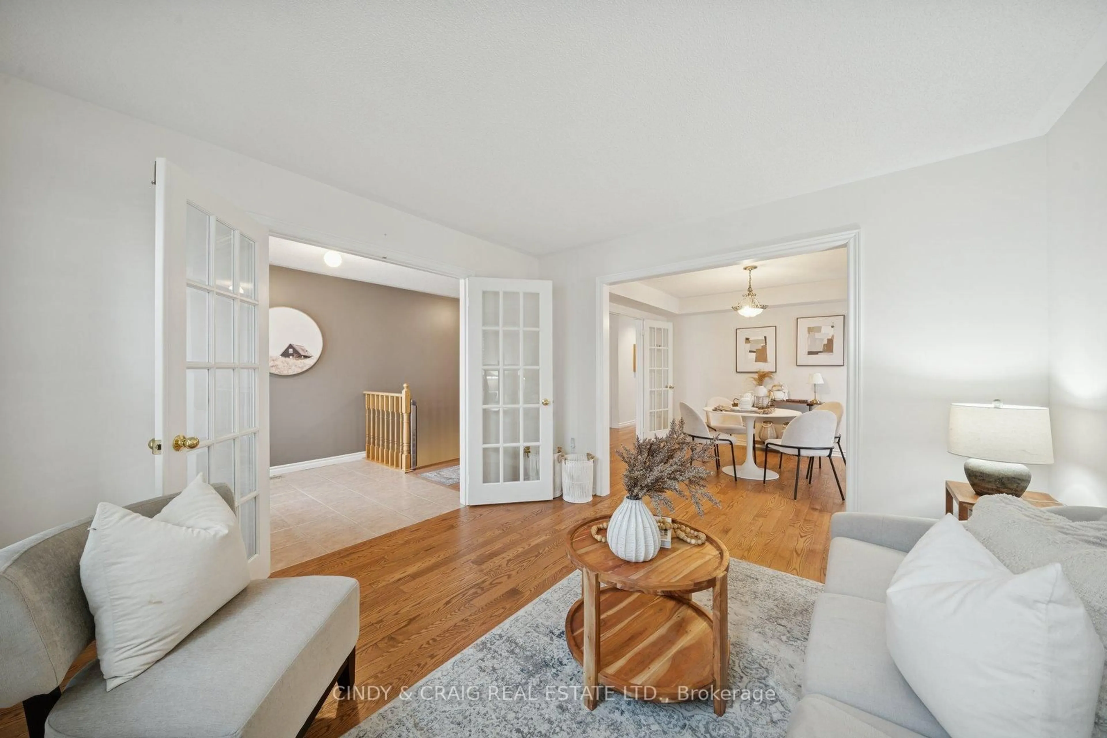 Living room with furniture, wood/laminate floor for 62 Foxhunt Tr, Clarington Ontario L1E 1E4