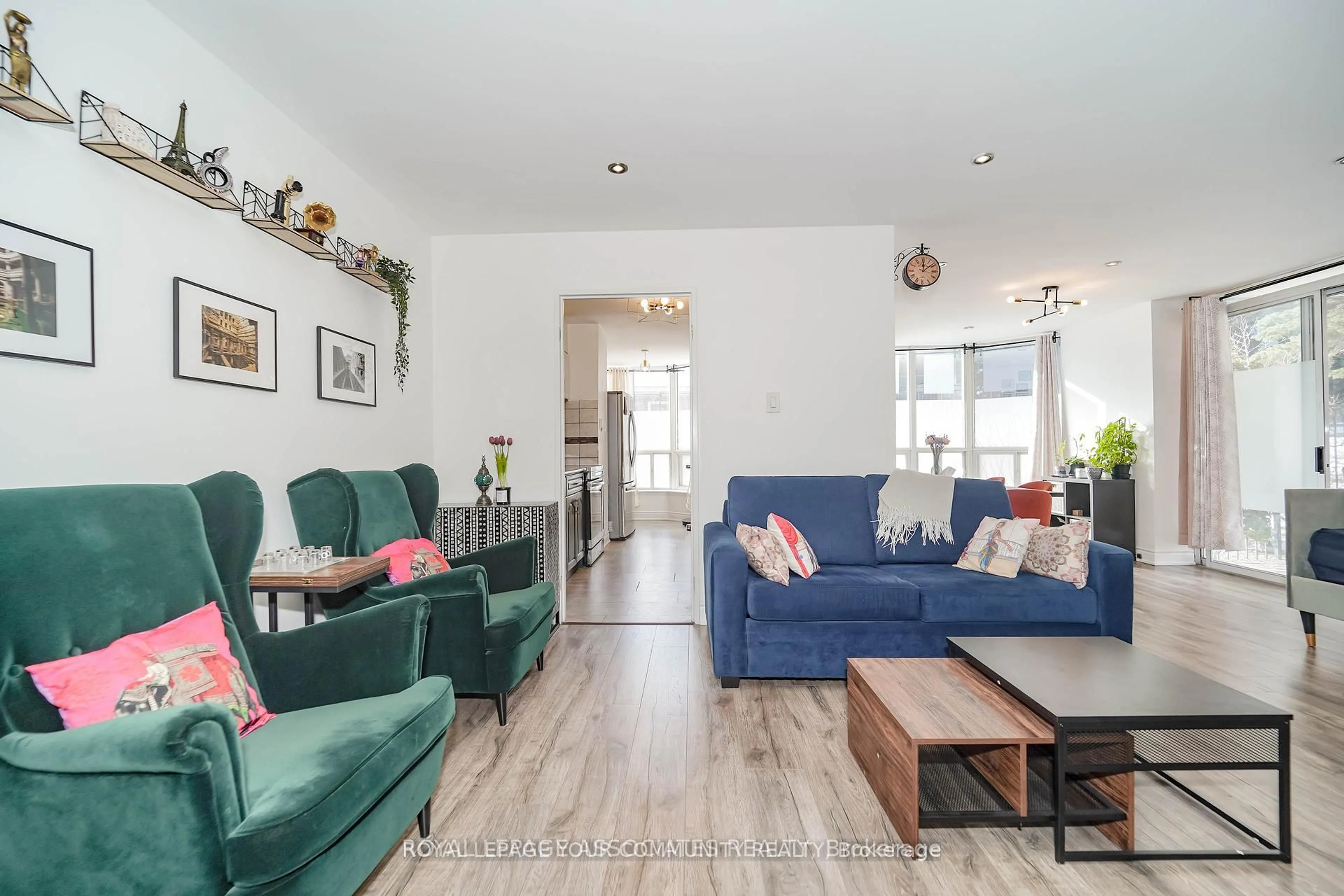 Living room with furniture, wood/laminate floor for 410 McLevin Ave #103, Toronto Ontario M1B 5J5