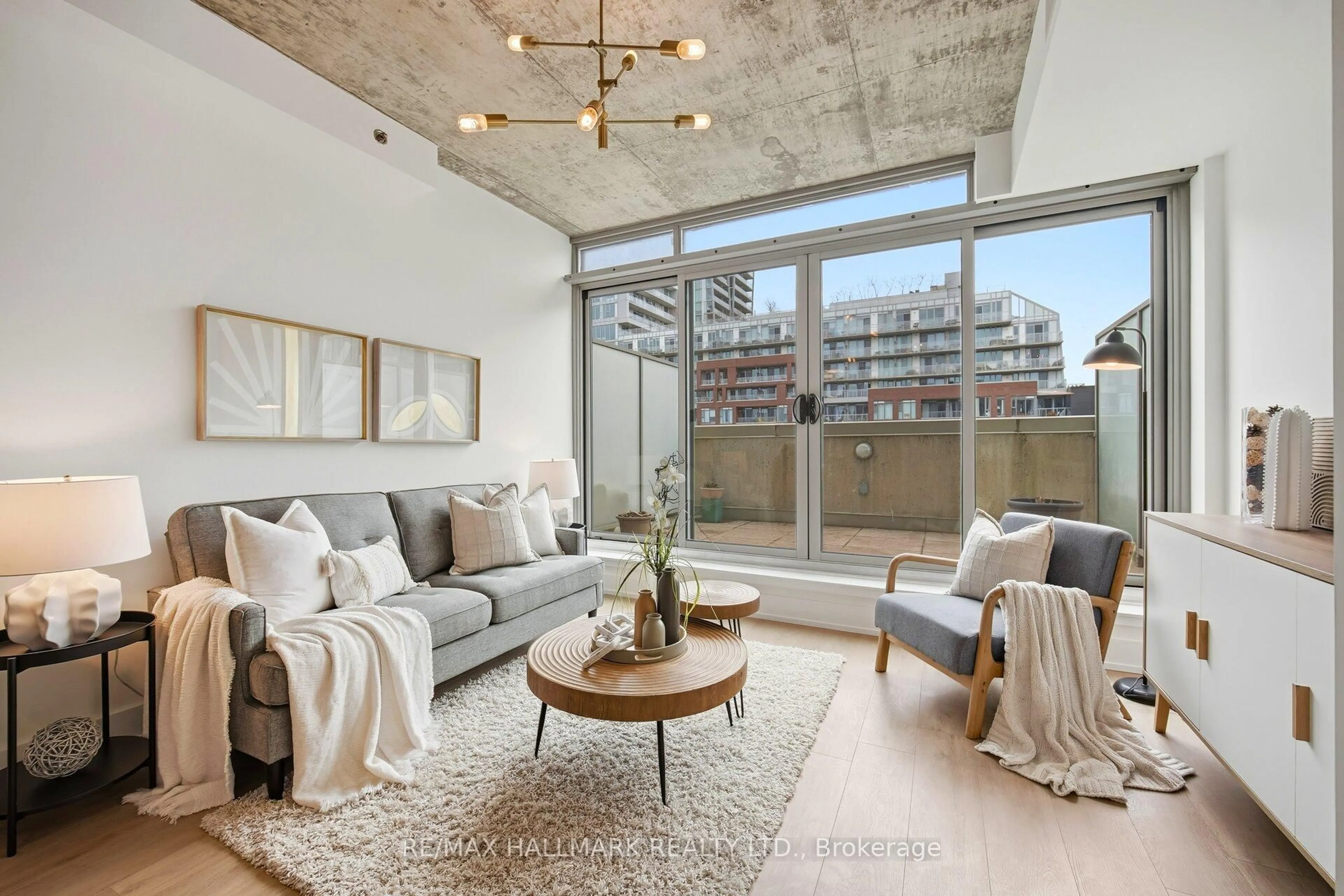 Living room with furniture, cement floor for 630 Queen St #511, Toronto Ontario M4M 1G3