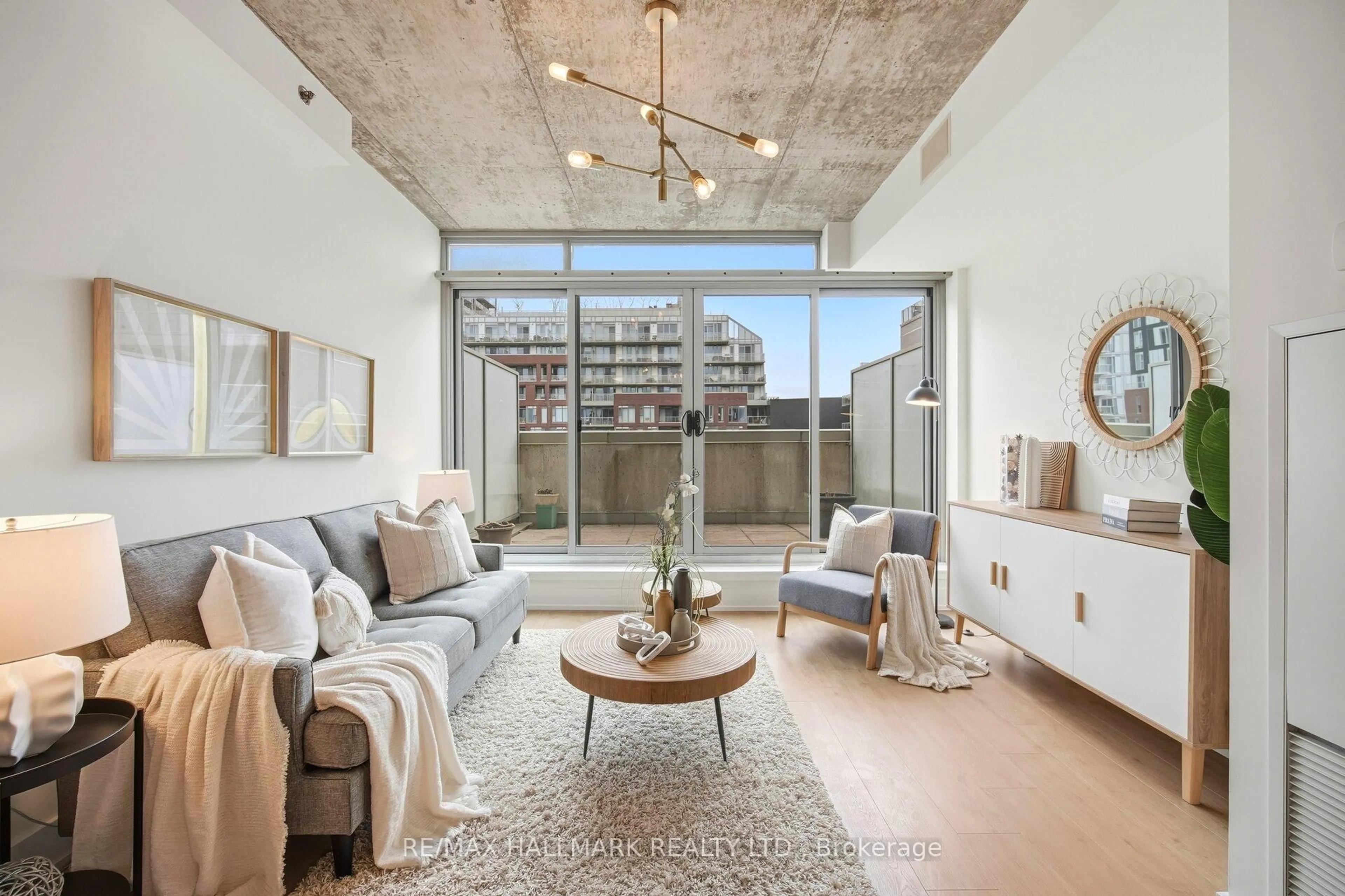 Living room with furniture, cement floor for 630 Queen St #511, Toronto Ontario M4M 1G3