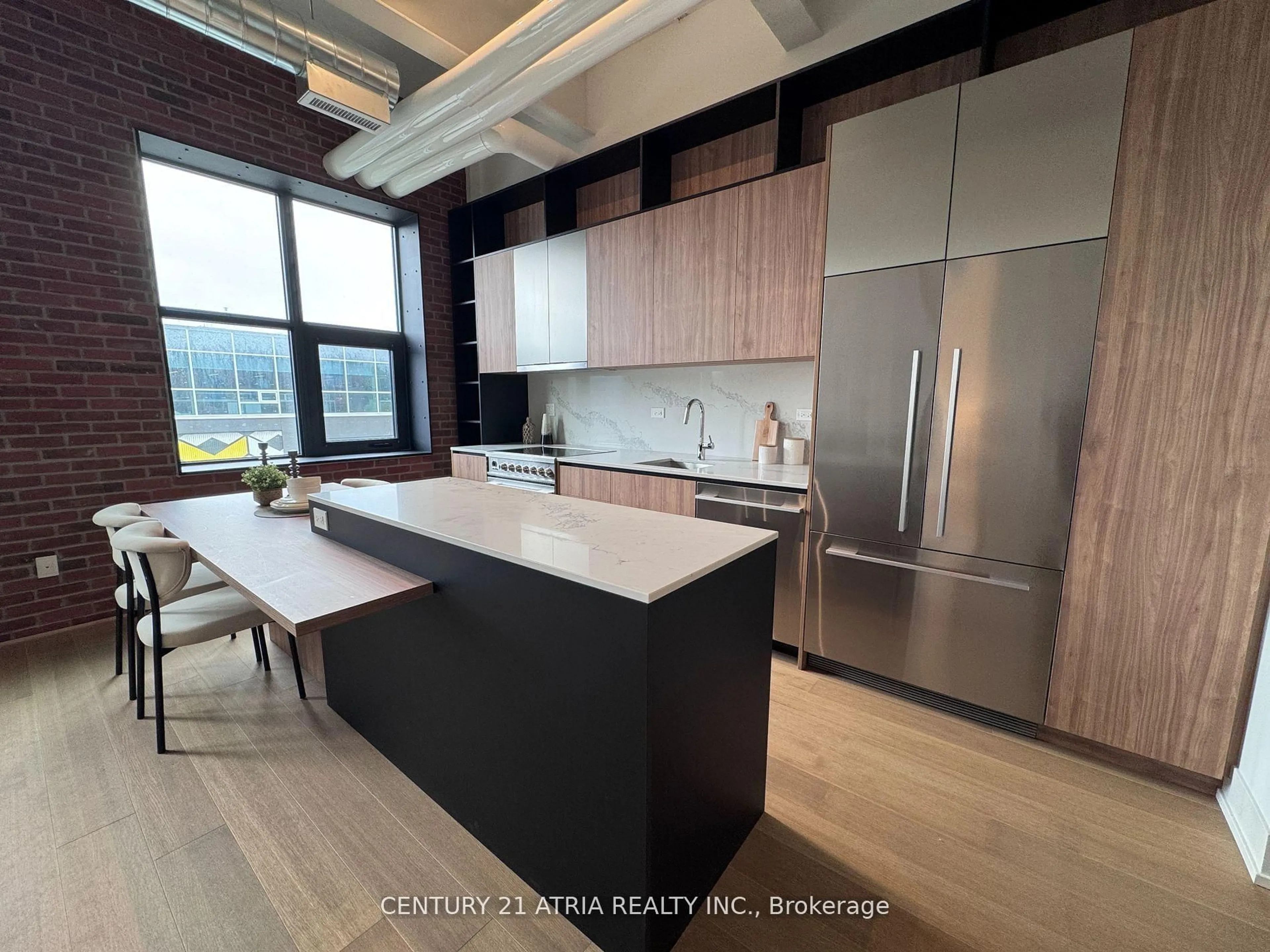 Open concept kitchen, wood/laminate floor for 150 Logan Ave #404, Toronto Ontario M4M 1C3