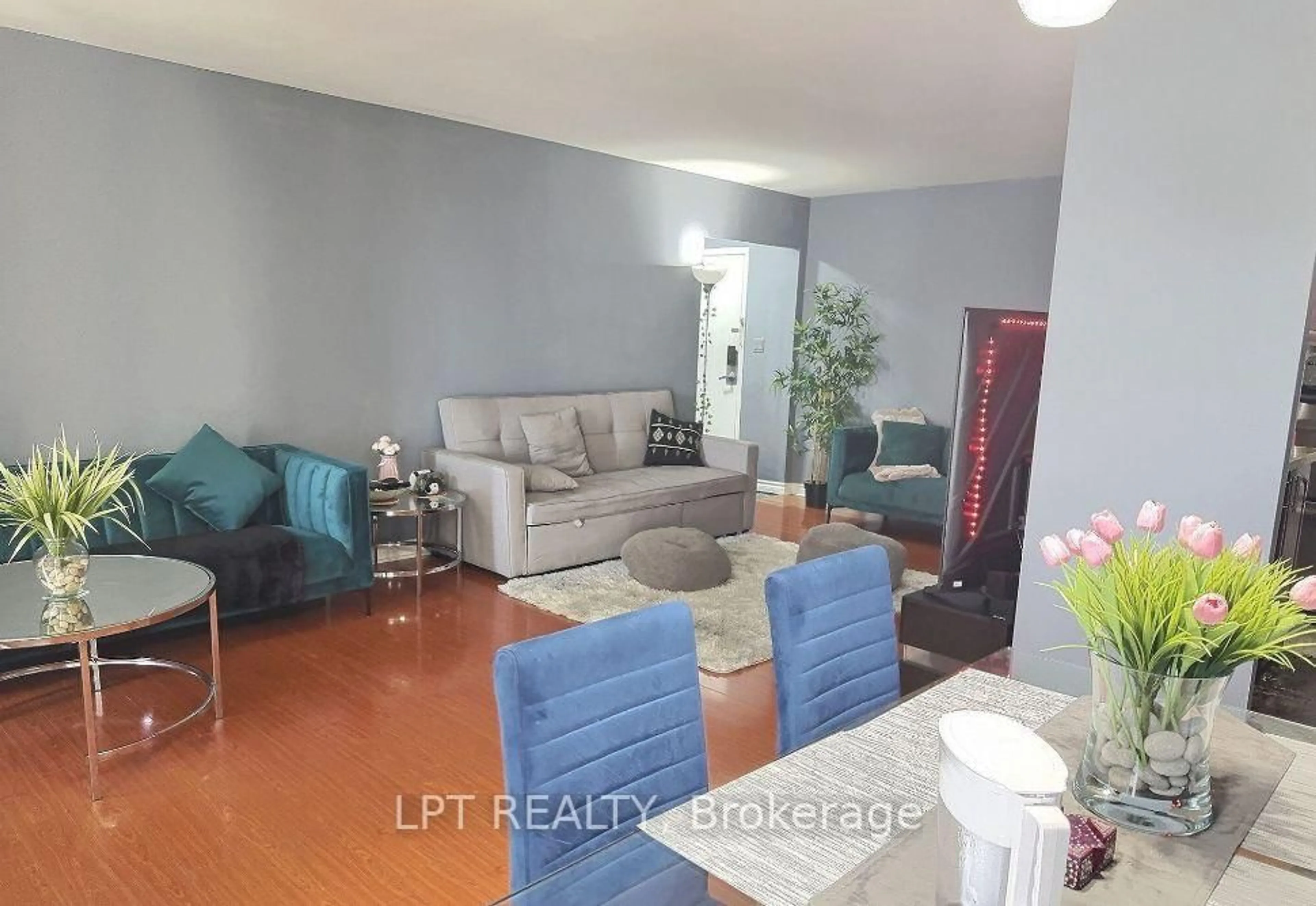 Living room with furniture, wood/laminate floor for 1 Massey Sq #1202, Toronto Ontario M4C 5L4