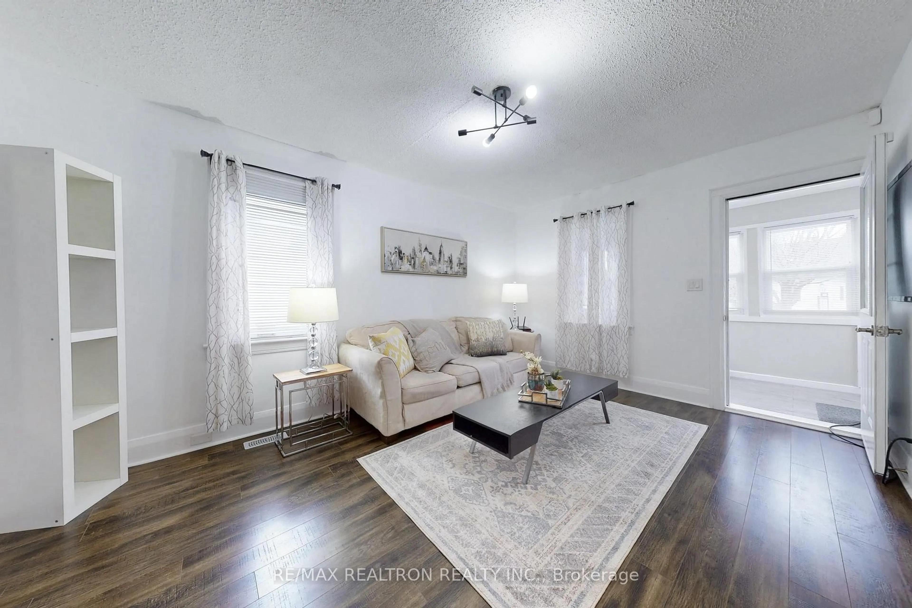 Living room with furniture, wood/laminate floor for 245 Quebec St, Oshawa Ontario L1J 1Y3