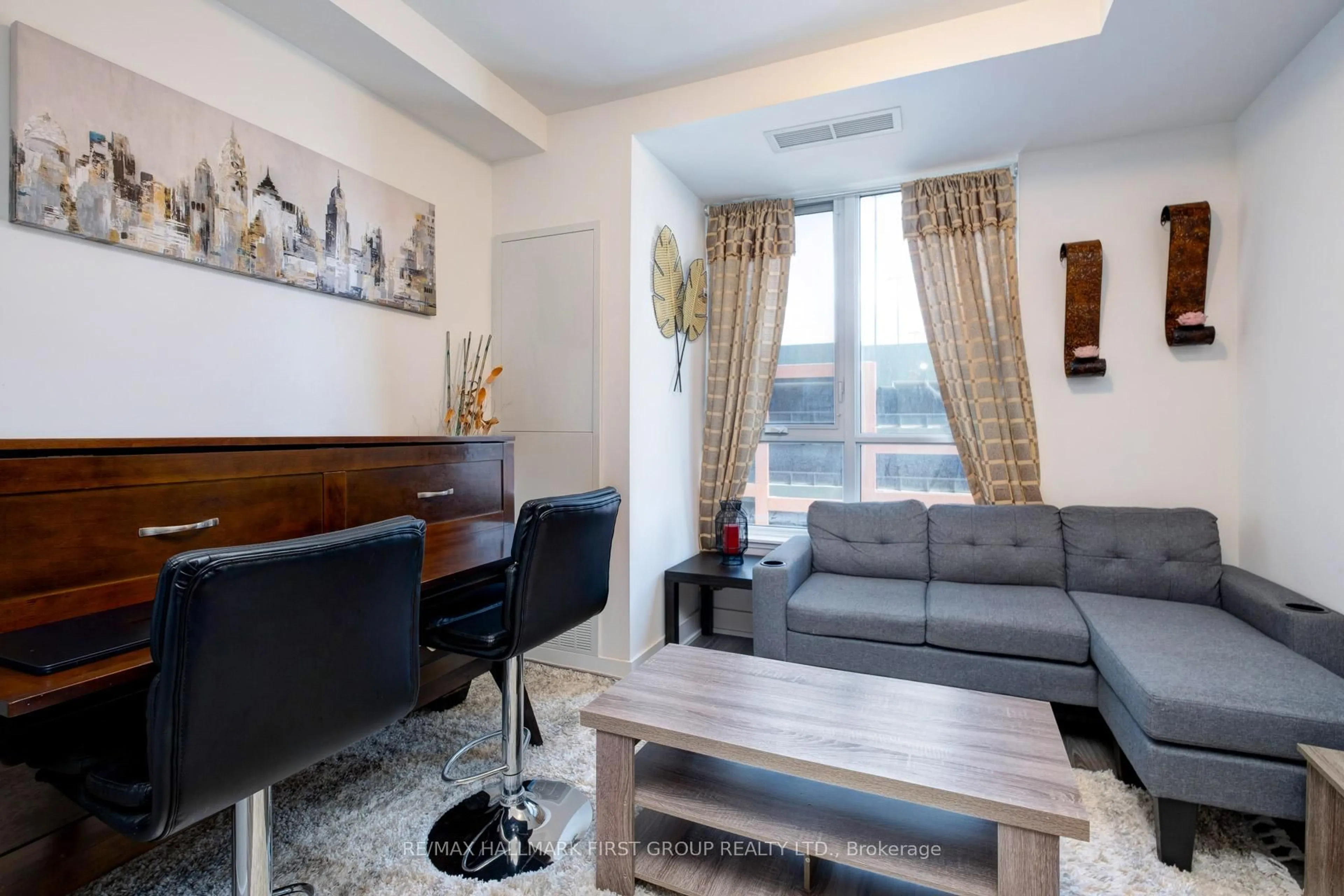 Living room with furniture, wood/laminate floor for 2545 Simcoe St #202, Oshawa Ontario L1H 7K4