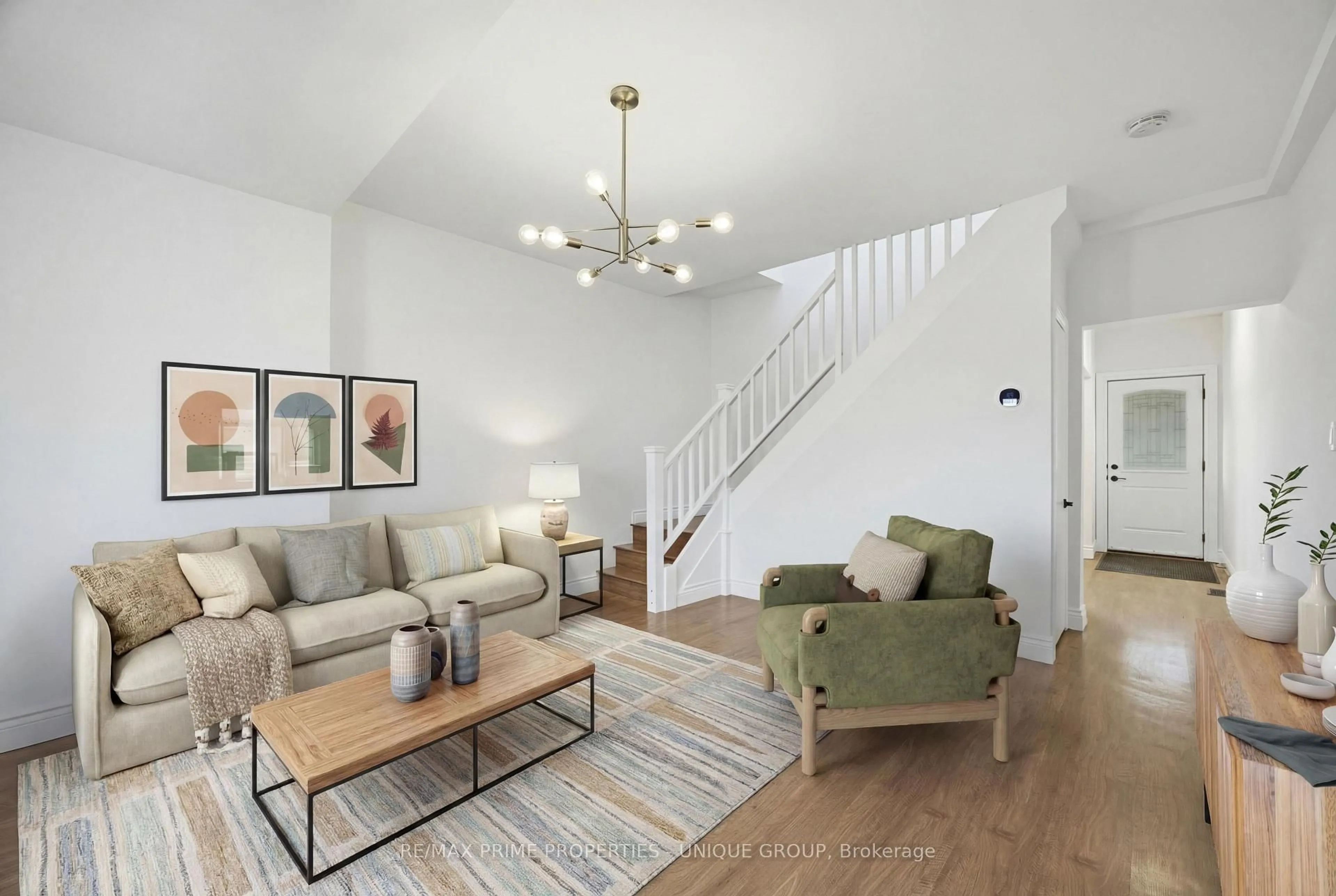 Living room with furniture, wood/laminate floor for 589 Logan Ave, Toronto Ontario M4K 3B9