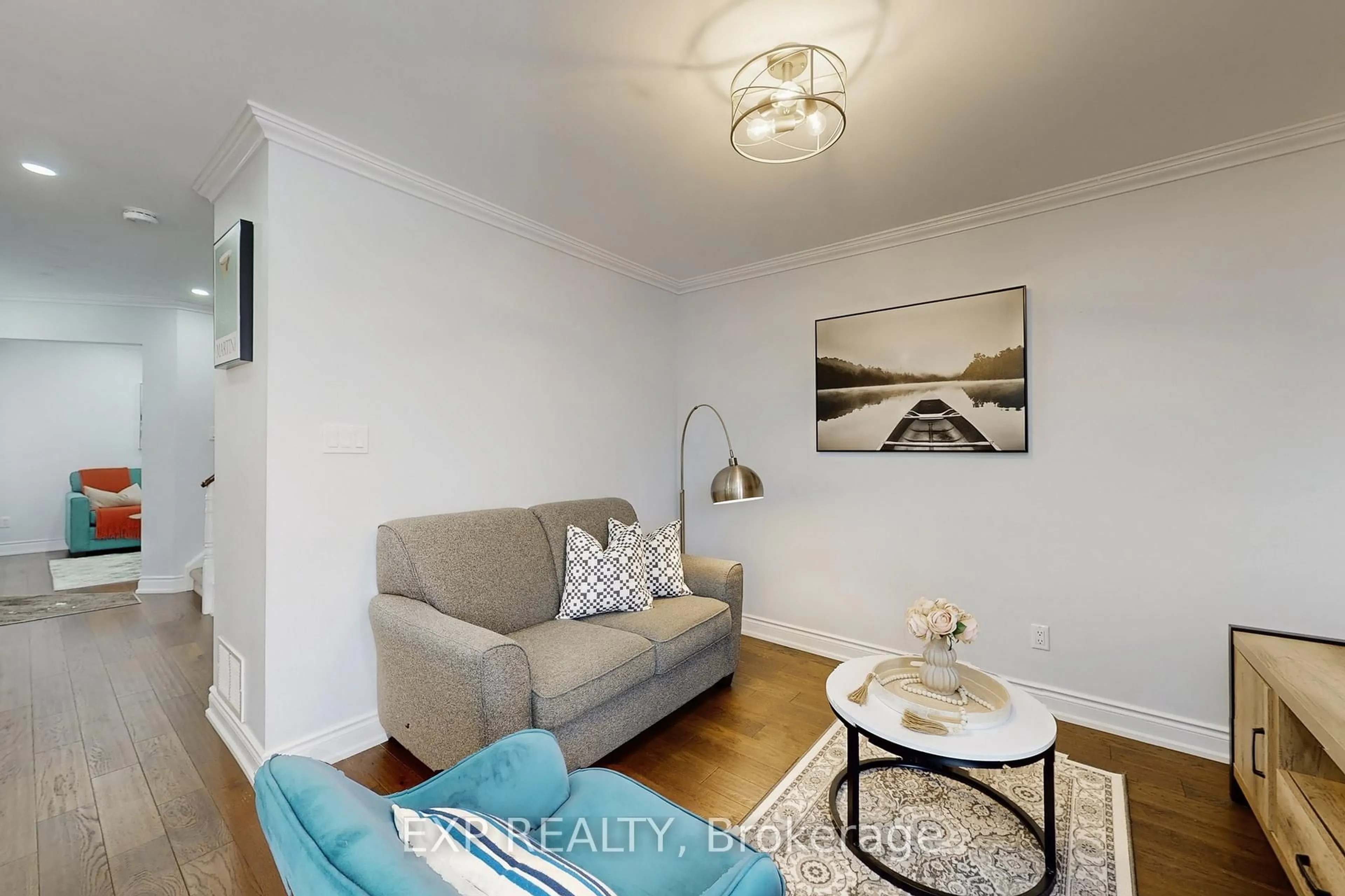 Living room with furniture, wood/laminate floor for 92 Hartrick Pl, Whitby Ontario L1R 2C3