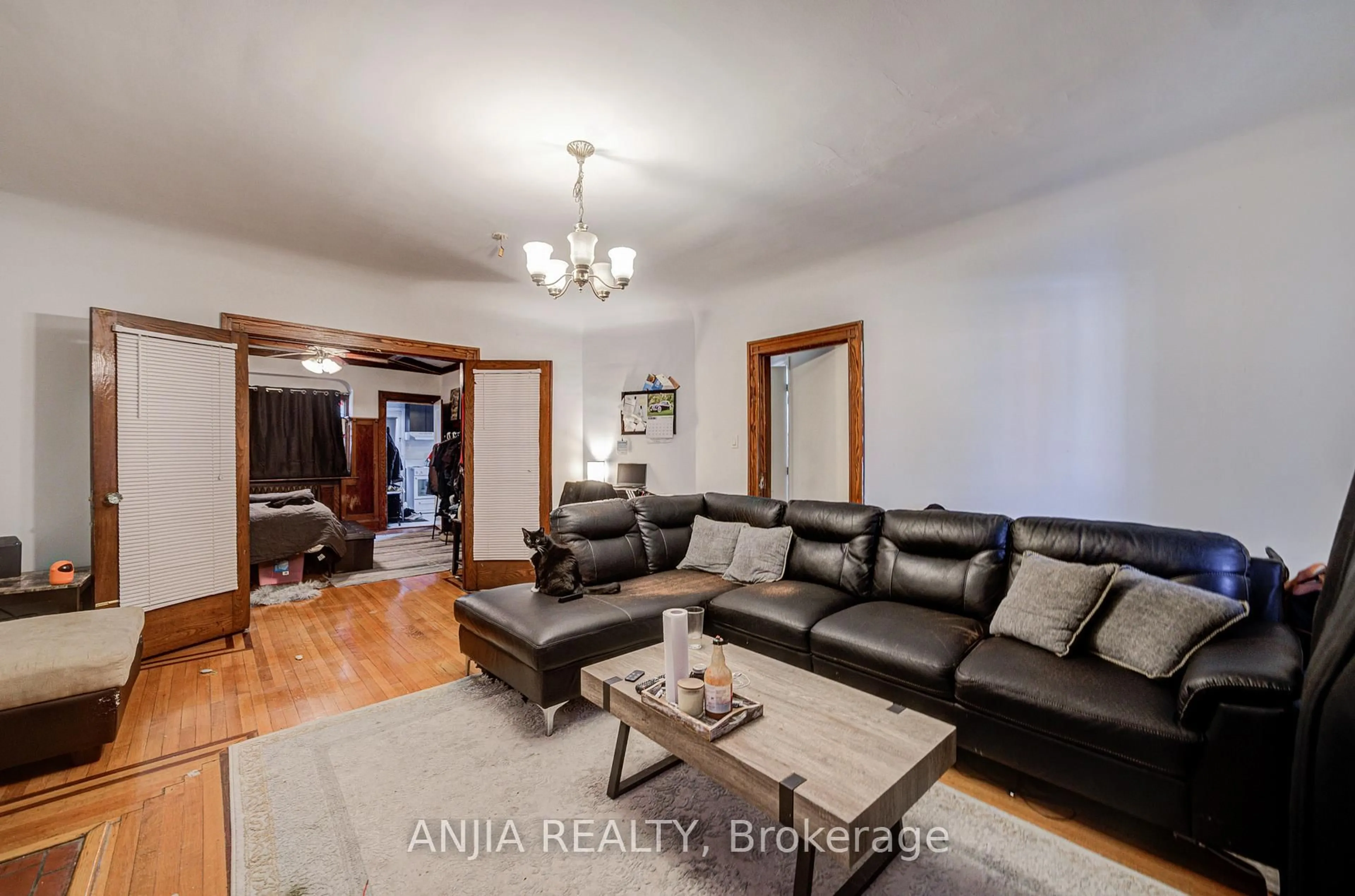 Living room with furniture, wood/laminate floor for 7 Linnsmore Cres, Toronto Ontario M4J 4J5
