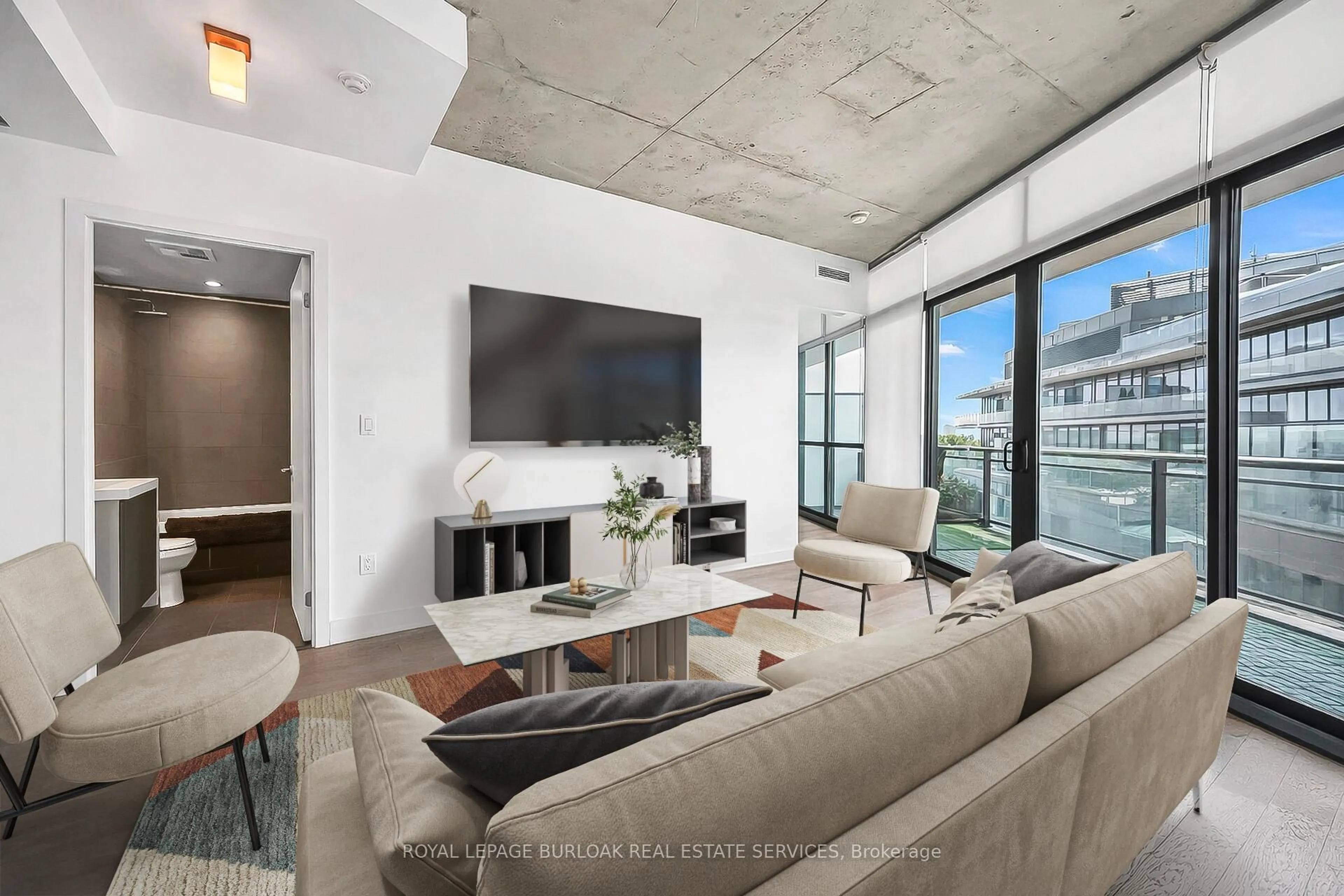 Living room with furniture, cement floor for 1201 Dundas St #902, Toronto Ontario M4M 1S2