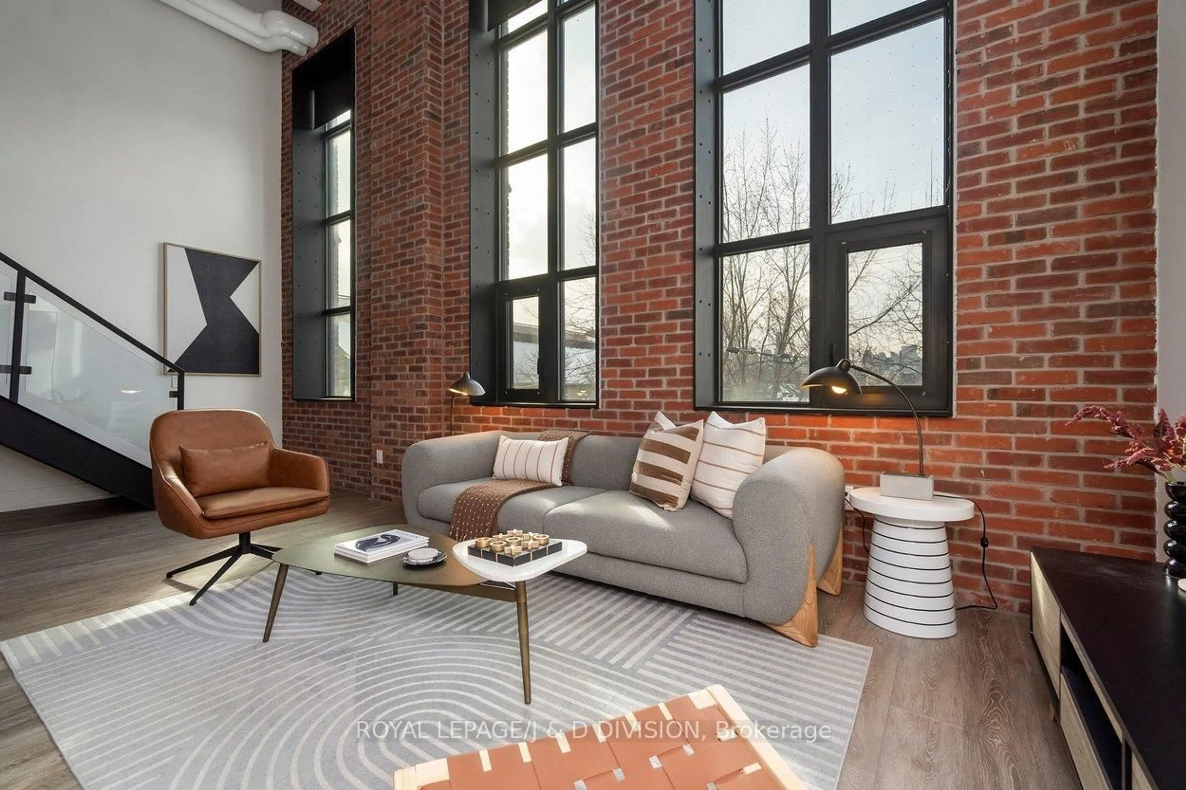 Living room with furniture, cement floor for 150 Logan Ave #409, Toronto Ontario M4M 0E4