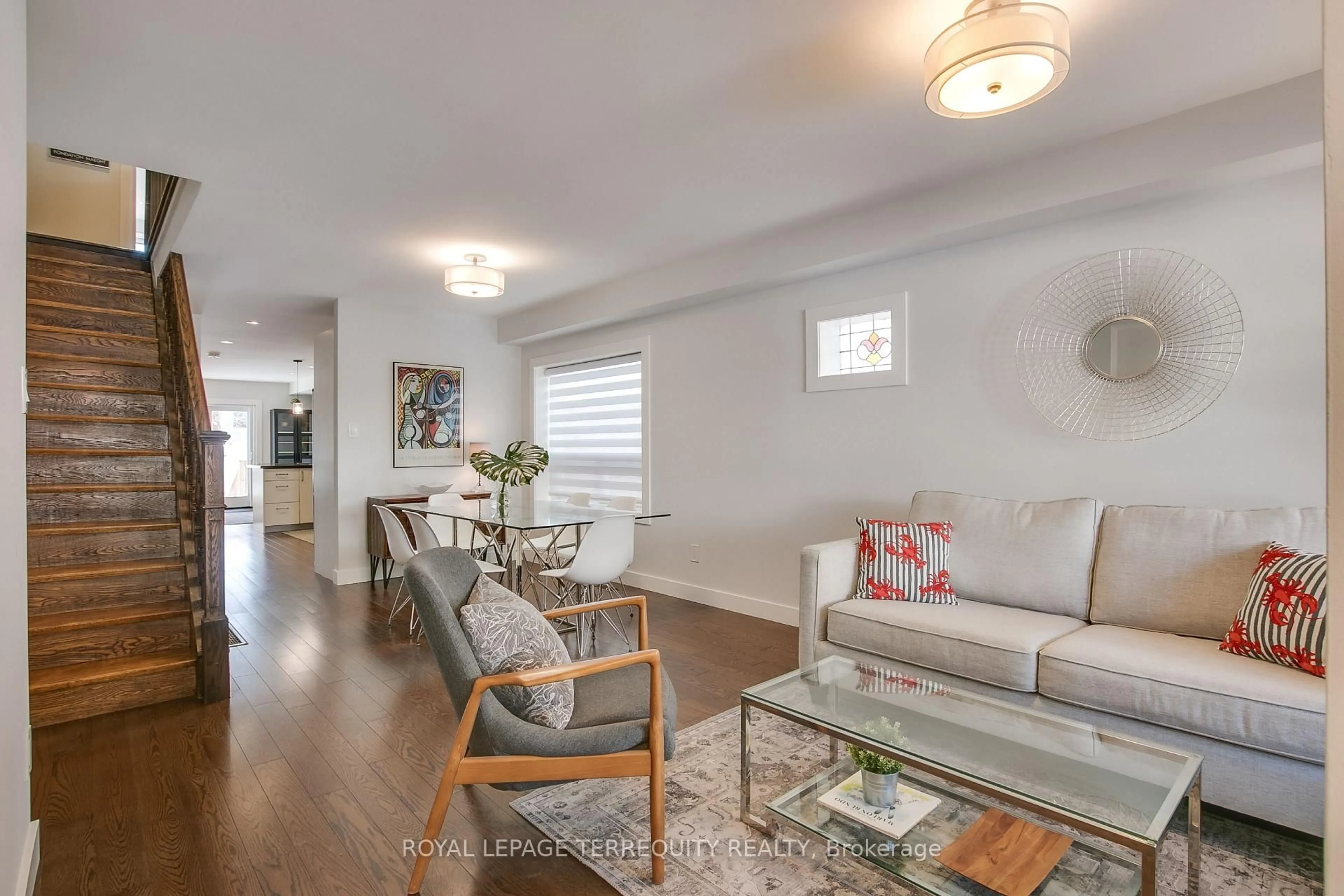 Living room with furniture, wood/laminate floor for 189 Queensdale Ave, Toronto Ontario M4C 2B1
