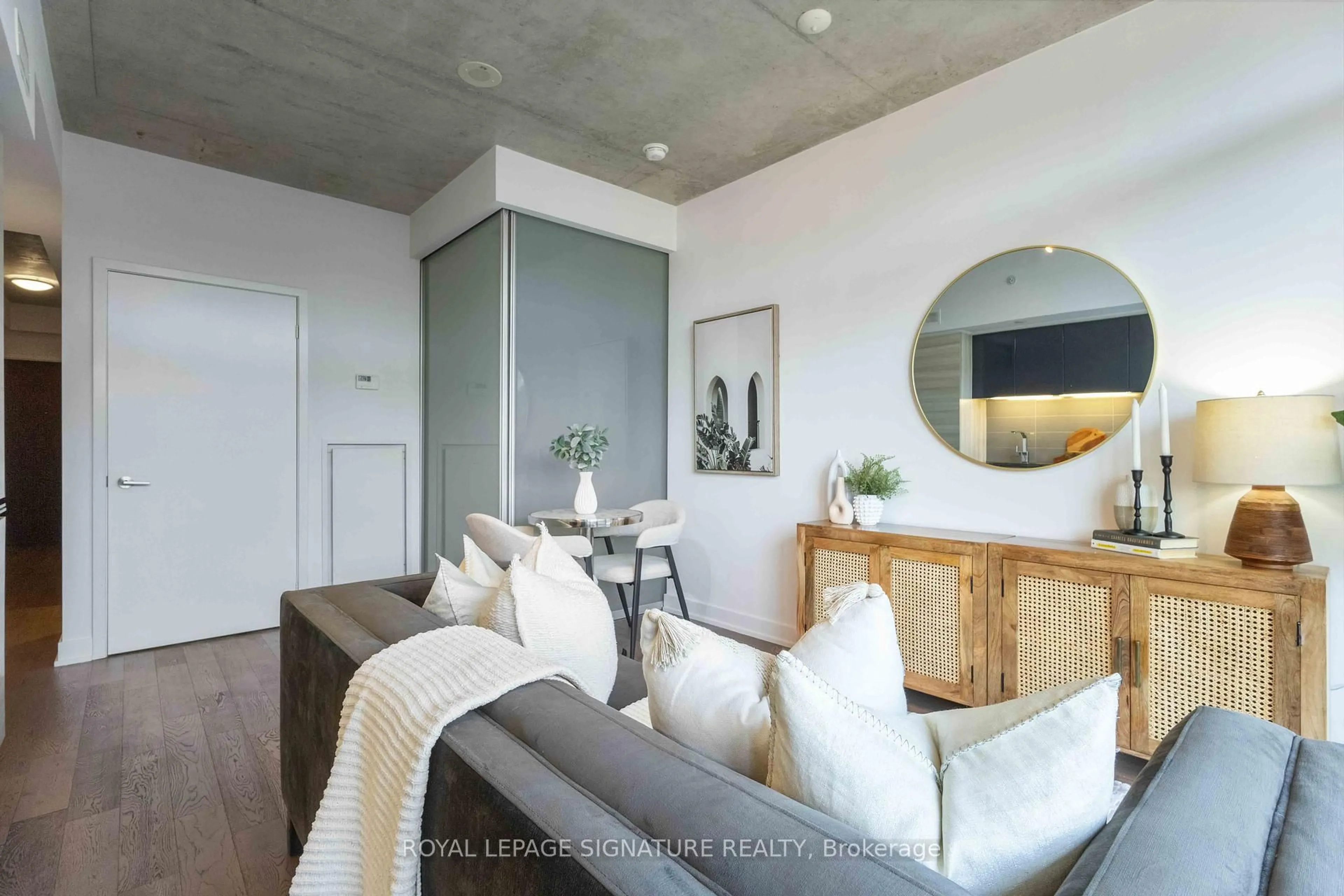 Living room with furniture, cement floor for 1190 Dundas St #406, Toronto Ontario M4M 0C5