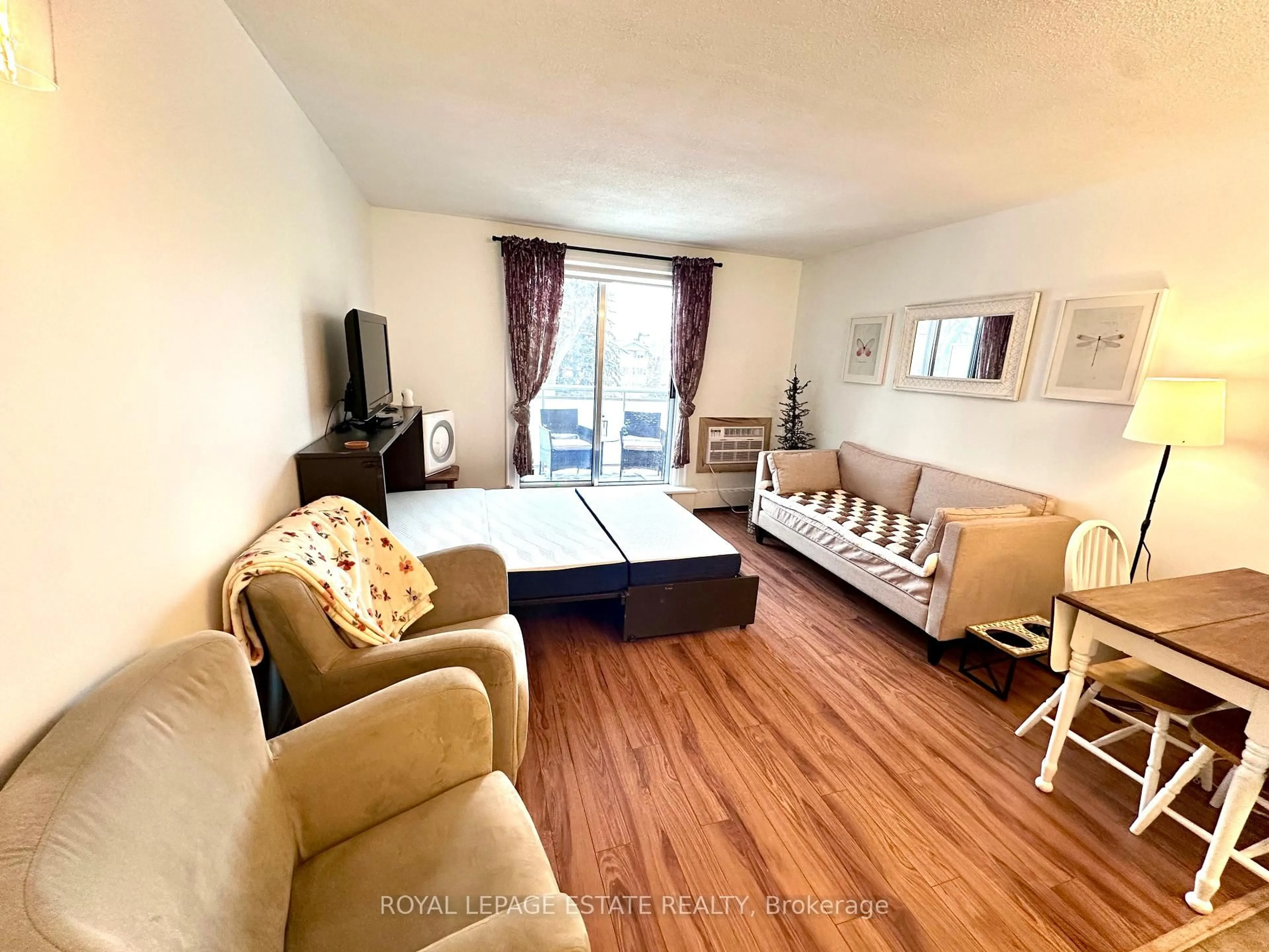 Living room with furniture, wood/laminate floor for 123 Woodbine Ave #309, Toronto Ontario M4L 3V8