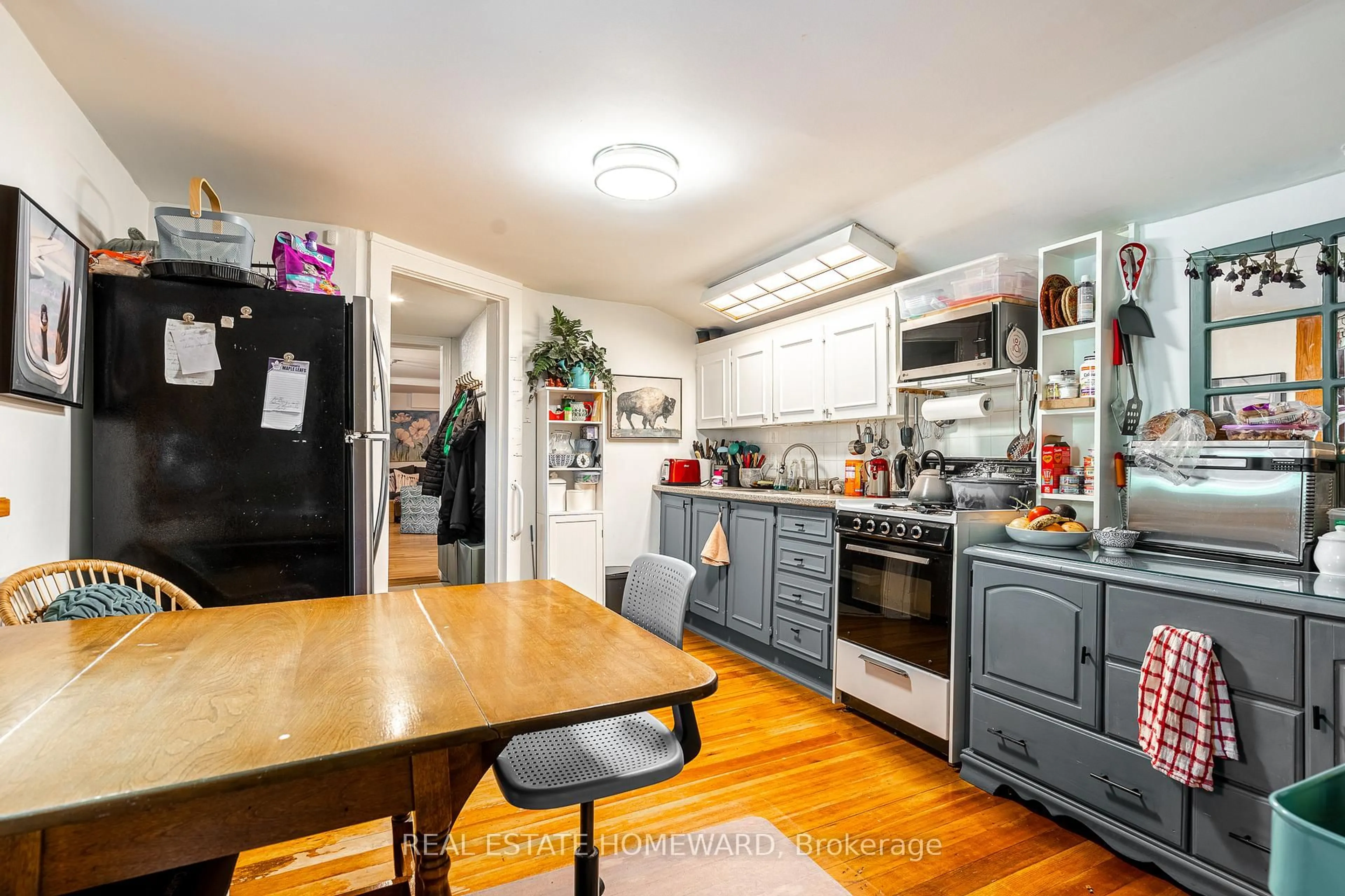 Open concept kitchen, wood/laminate floor for 3025 Queen St, Toronto Ontario M1N 1A5