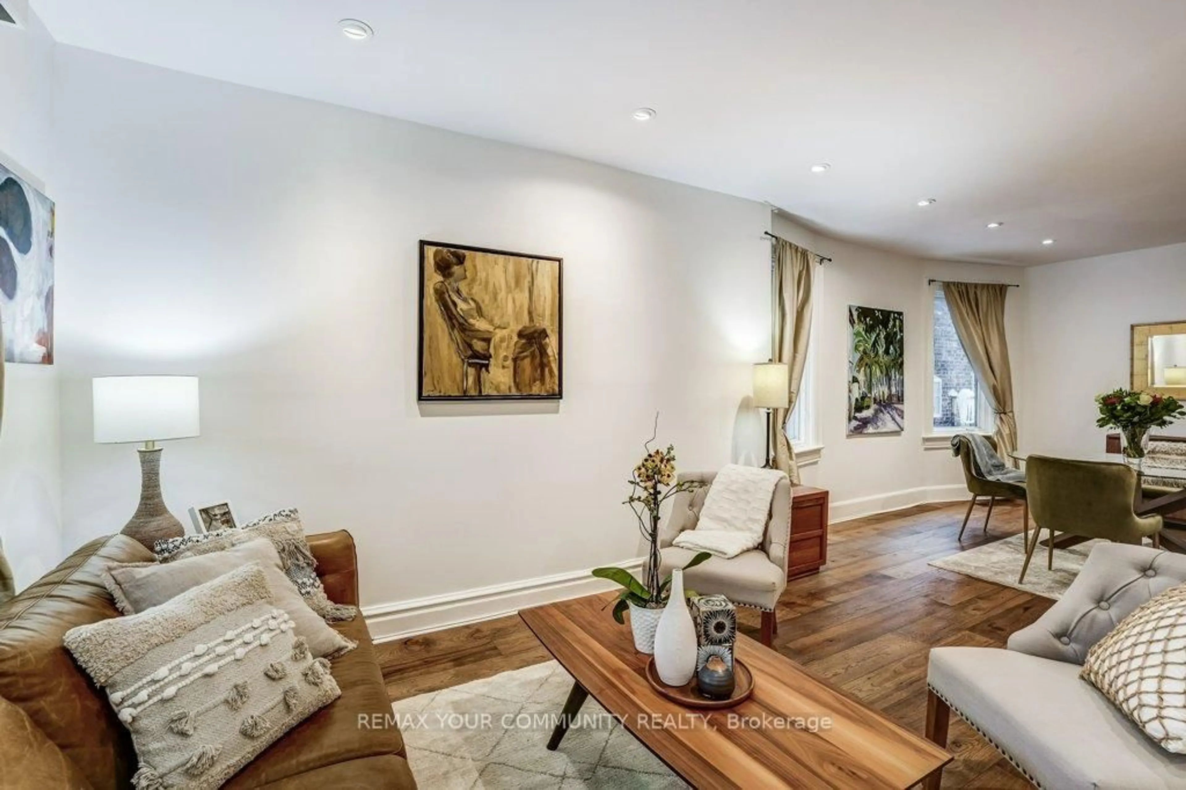 Living room with furniture, wood/laminate floor for 11 1/2 Sparkhall Ave, Toronto Ontario M4K 1G4