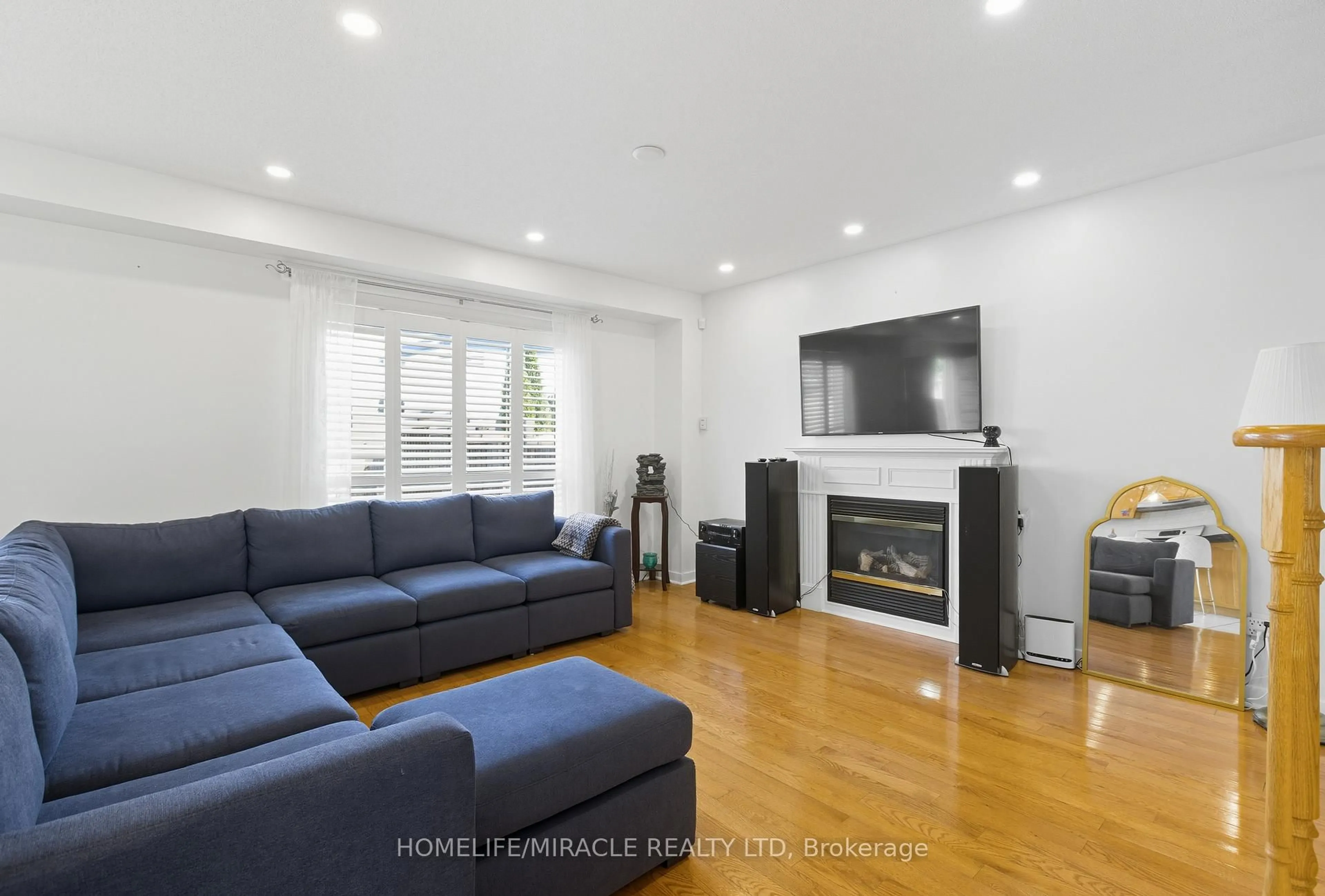 Living room with furniture, wood/laminate floor for 12 Robert Attersley Dr, Whitby Ontario L1R 3E3