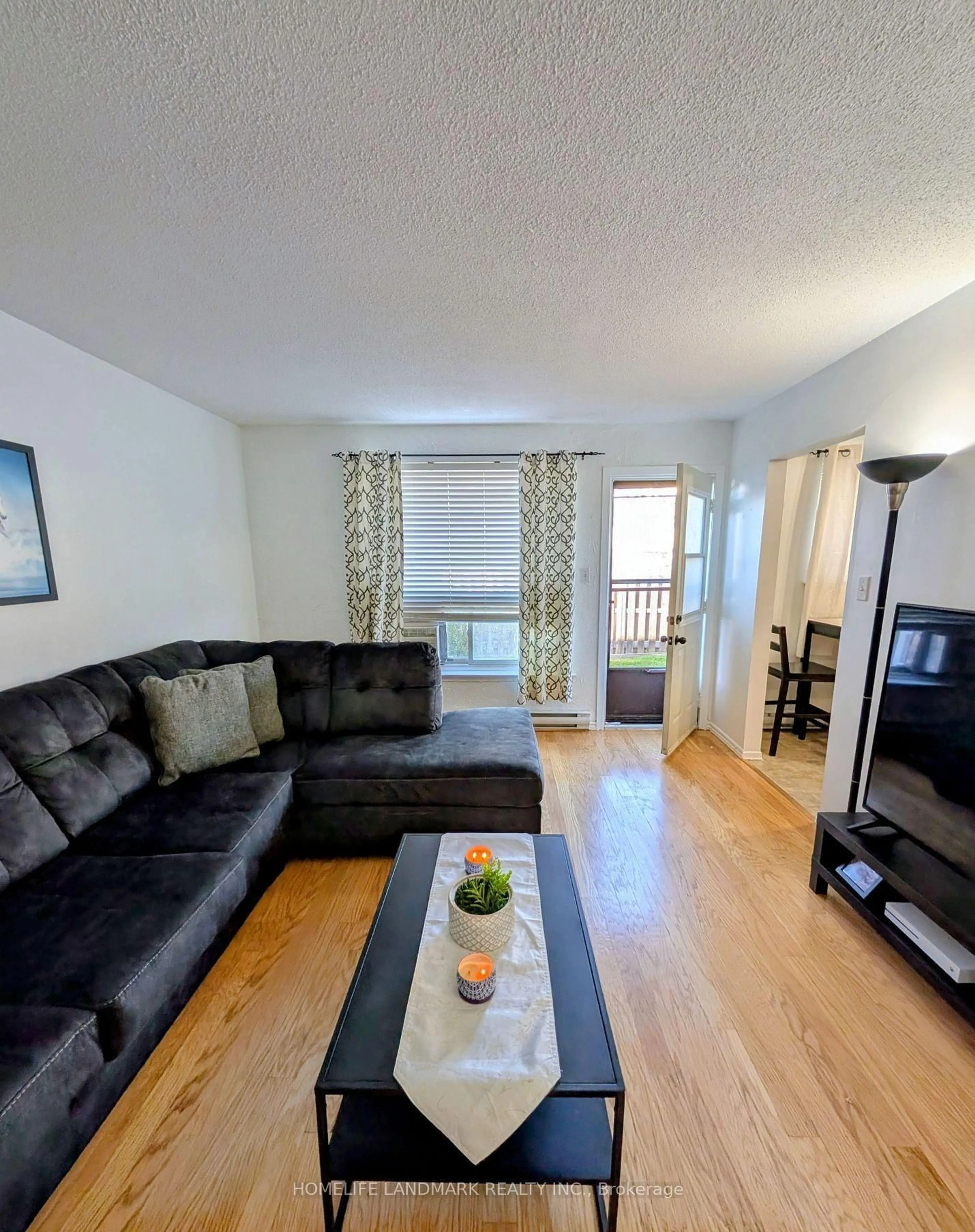 Living room with furniture, wood/laminate floor for 120 Nonquon Rd #15, Oshawa Ontario L1G 7E6