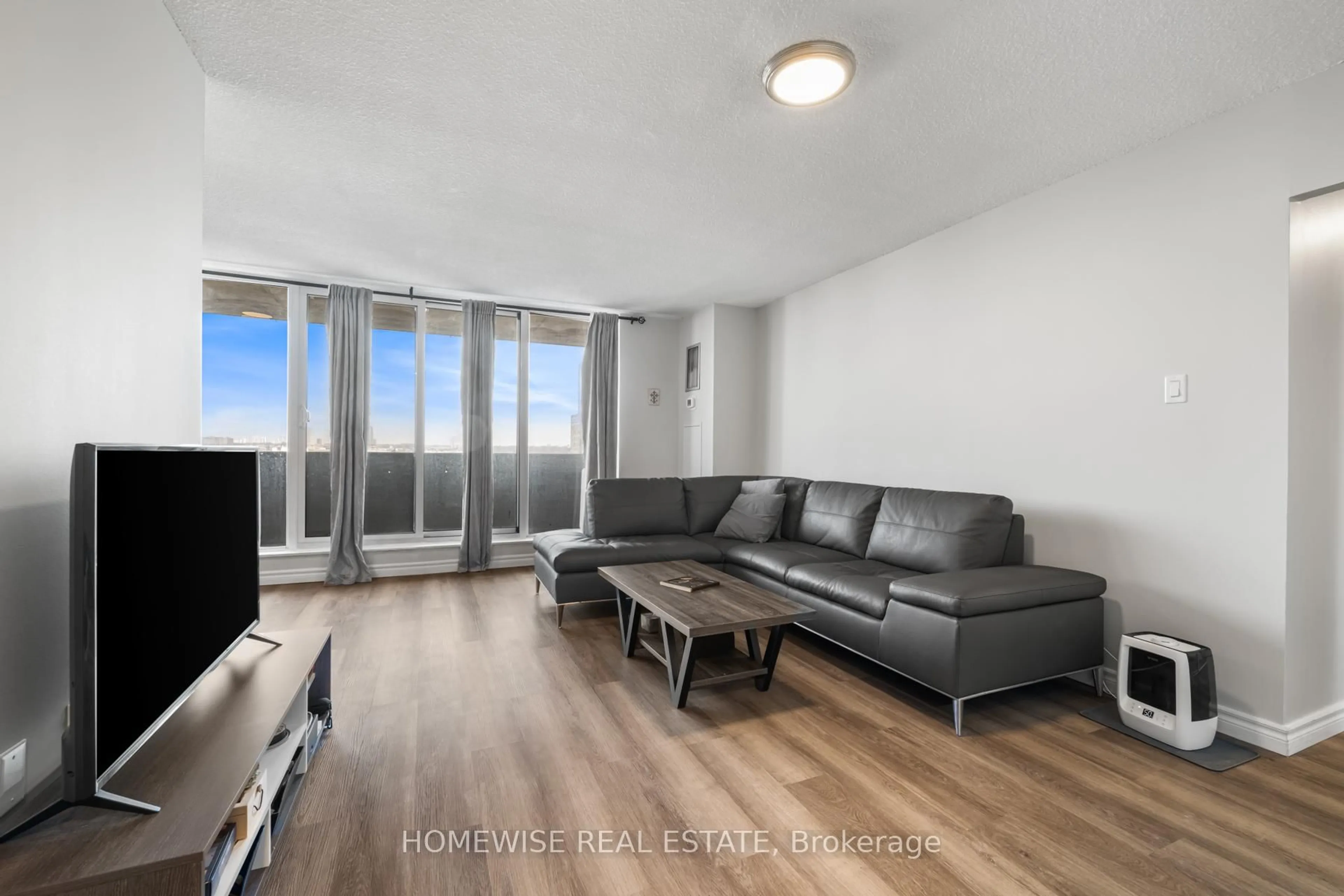 Living room with furniture, wood/laminate floor for 100 Prudential Dr #909, Toronto Ontario M1P 4V4