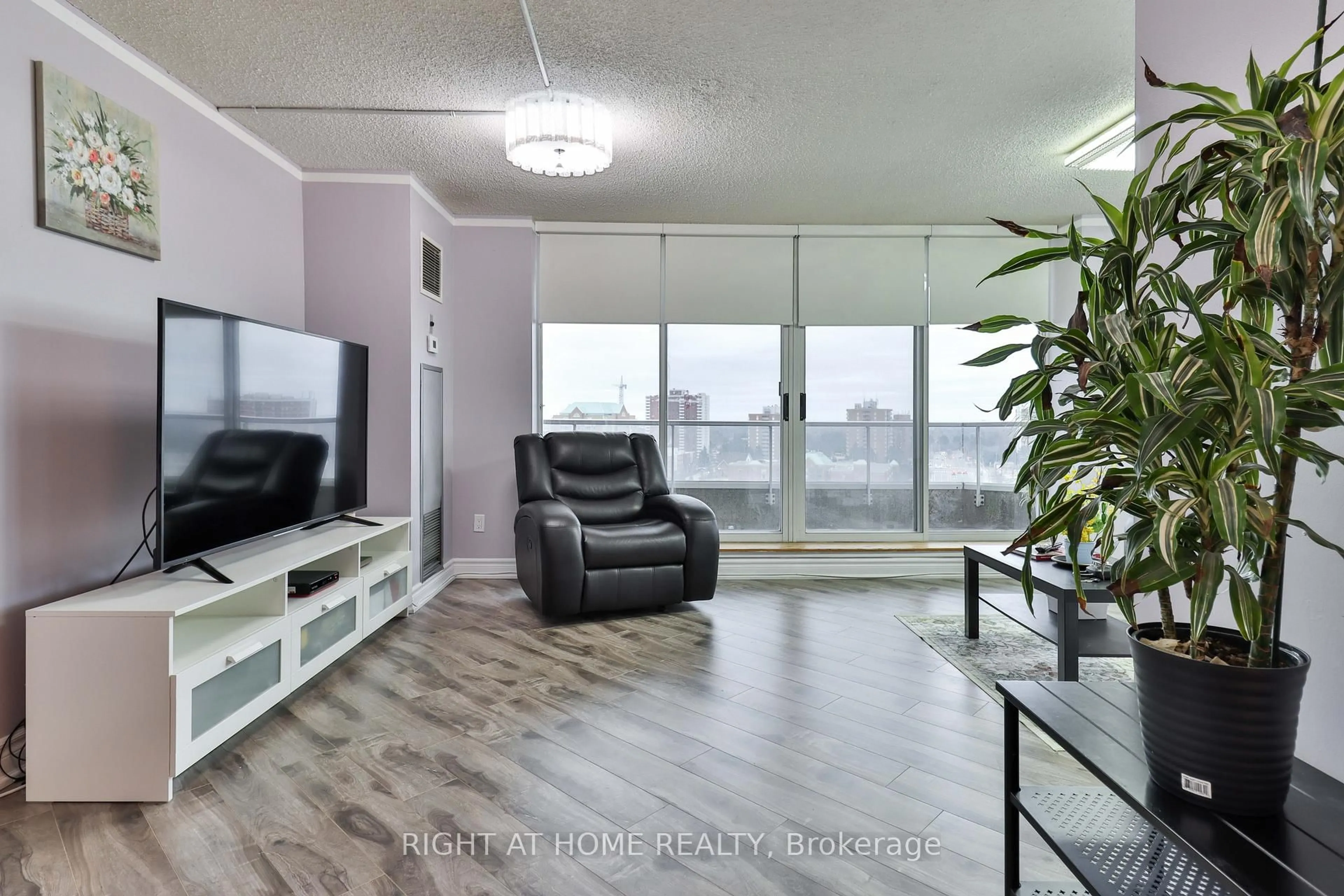 Living room with furniture, wood/laminate floor for 410 Mclevin Ave #1609, Toronto Ontario M1B 5J5
