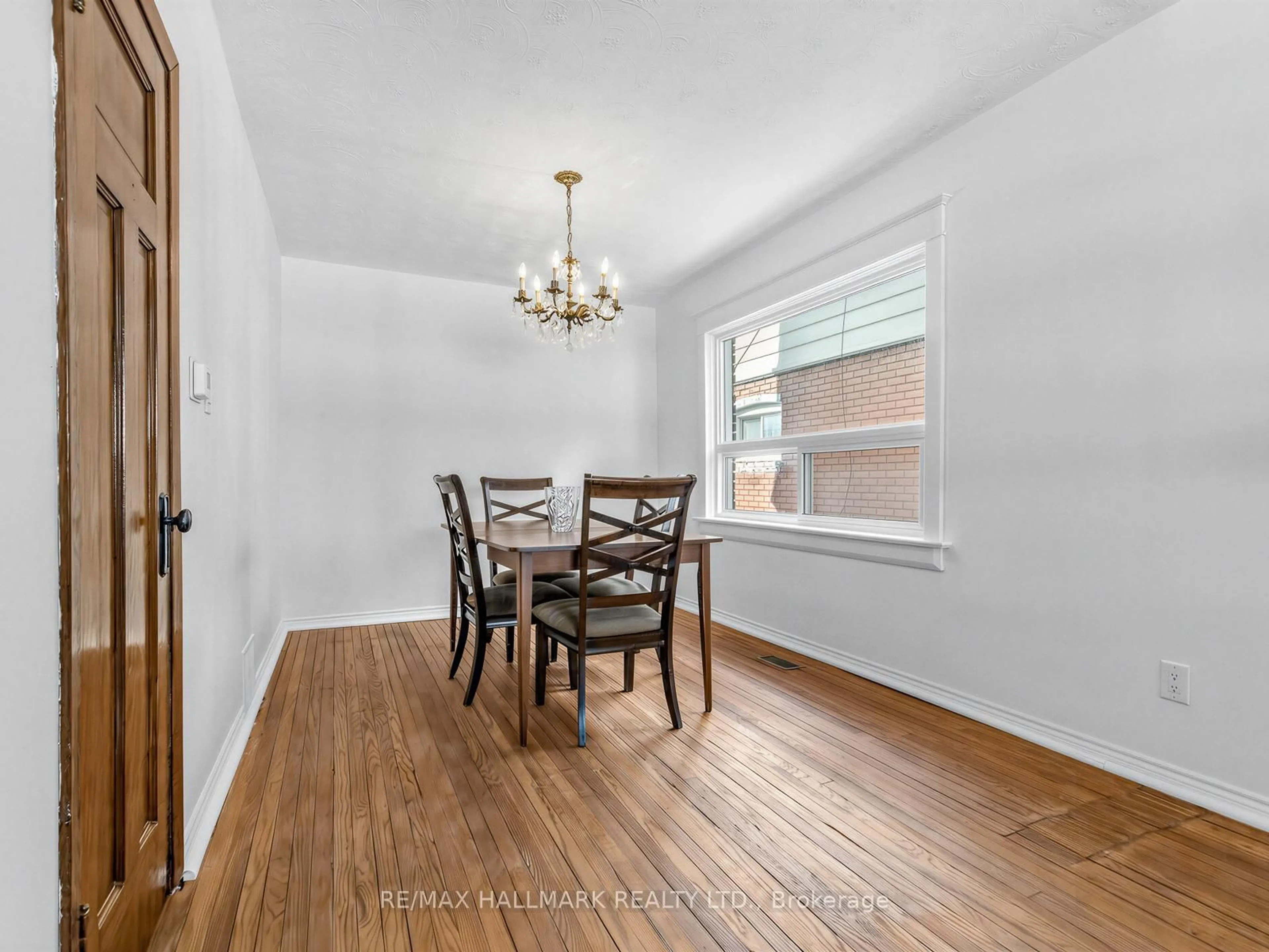 Dining room, wood/laminate floor for 102 Caithness Ave, Toronto Ontario M4J 3Y1