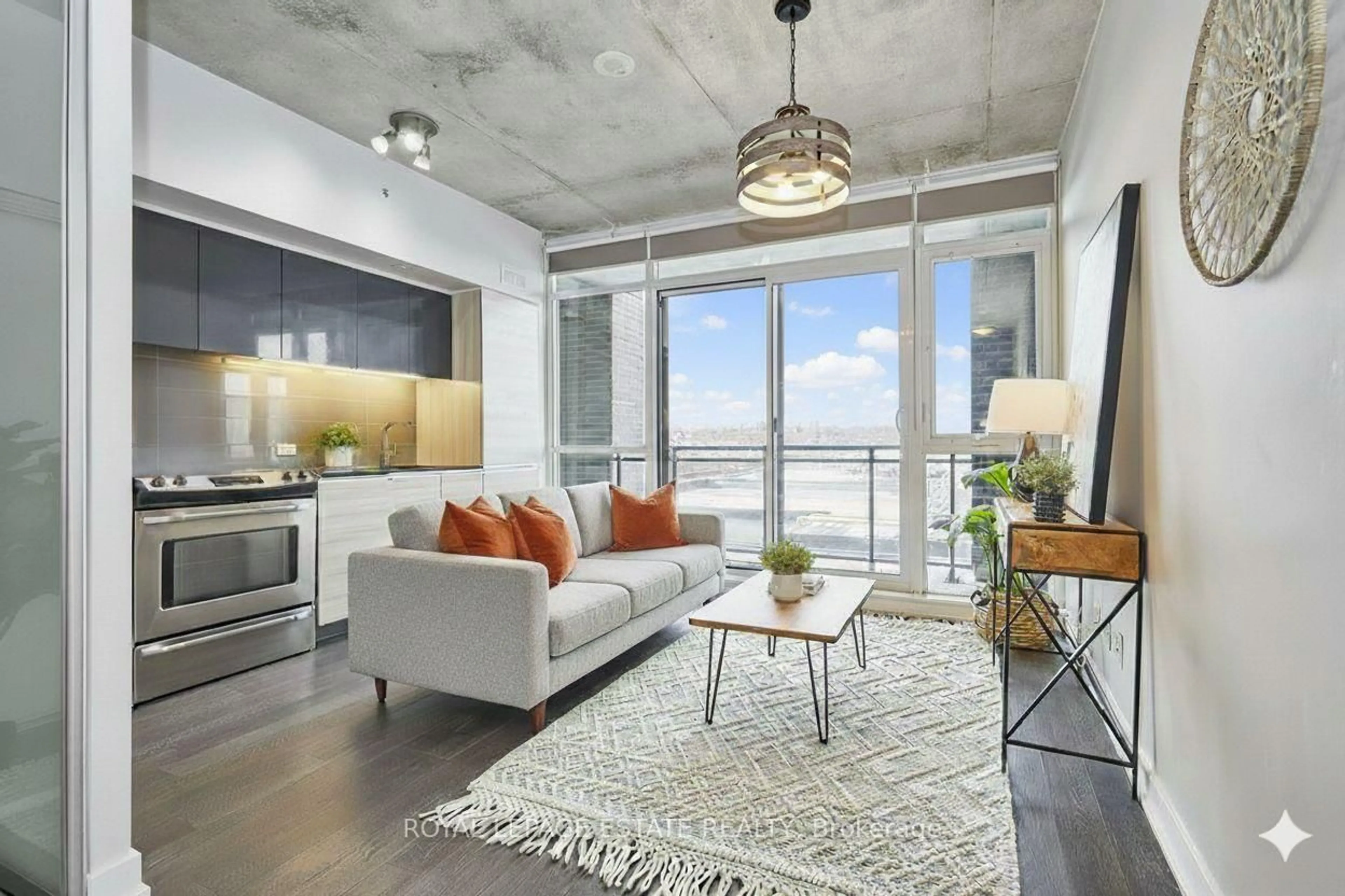 Living room with furniture, cement floor for 1190 Dundas St #525, Toronto Ontario M4M 0C5