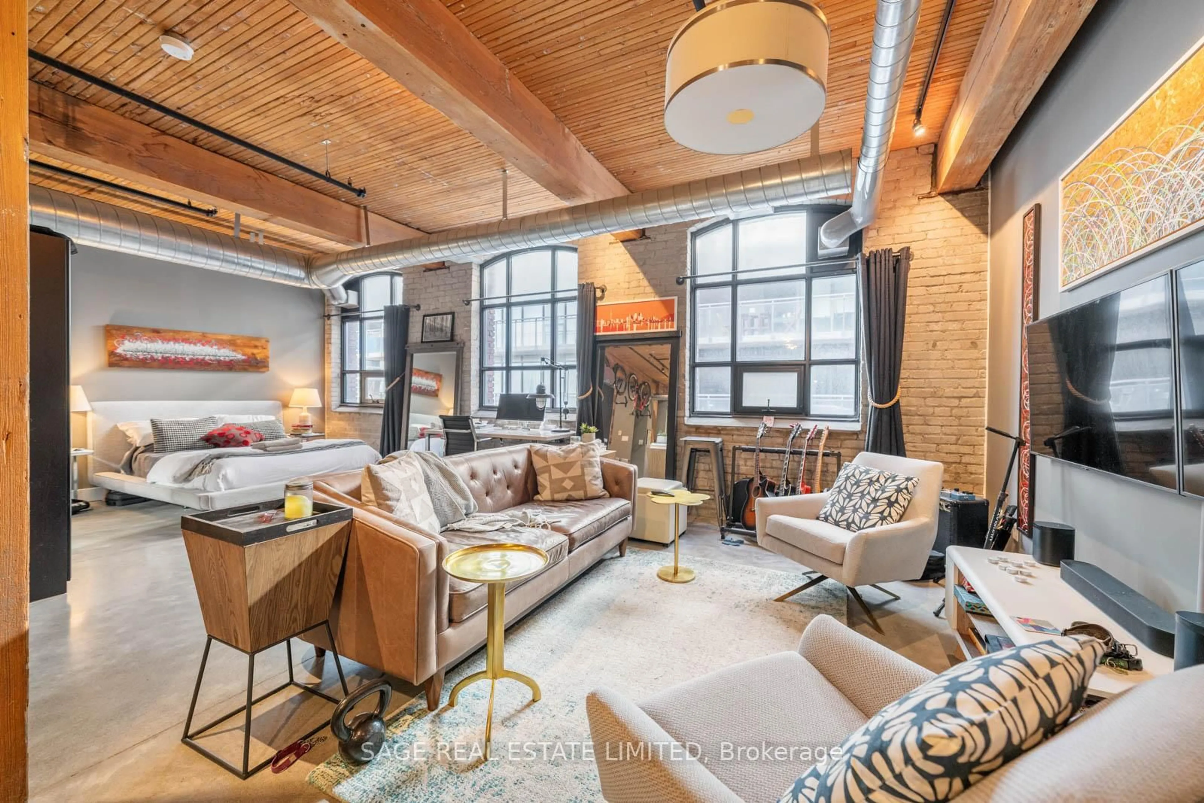 Living room with furniture, cement floor for 68 Broadview Ave #409, Toronto Ontario M4M 2E6