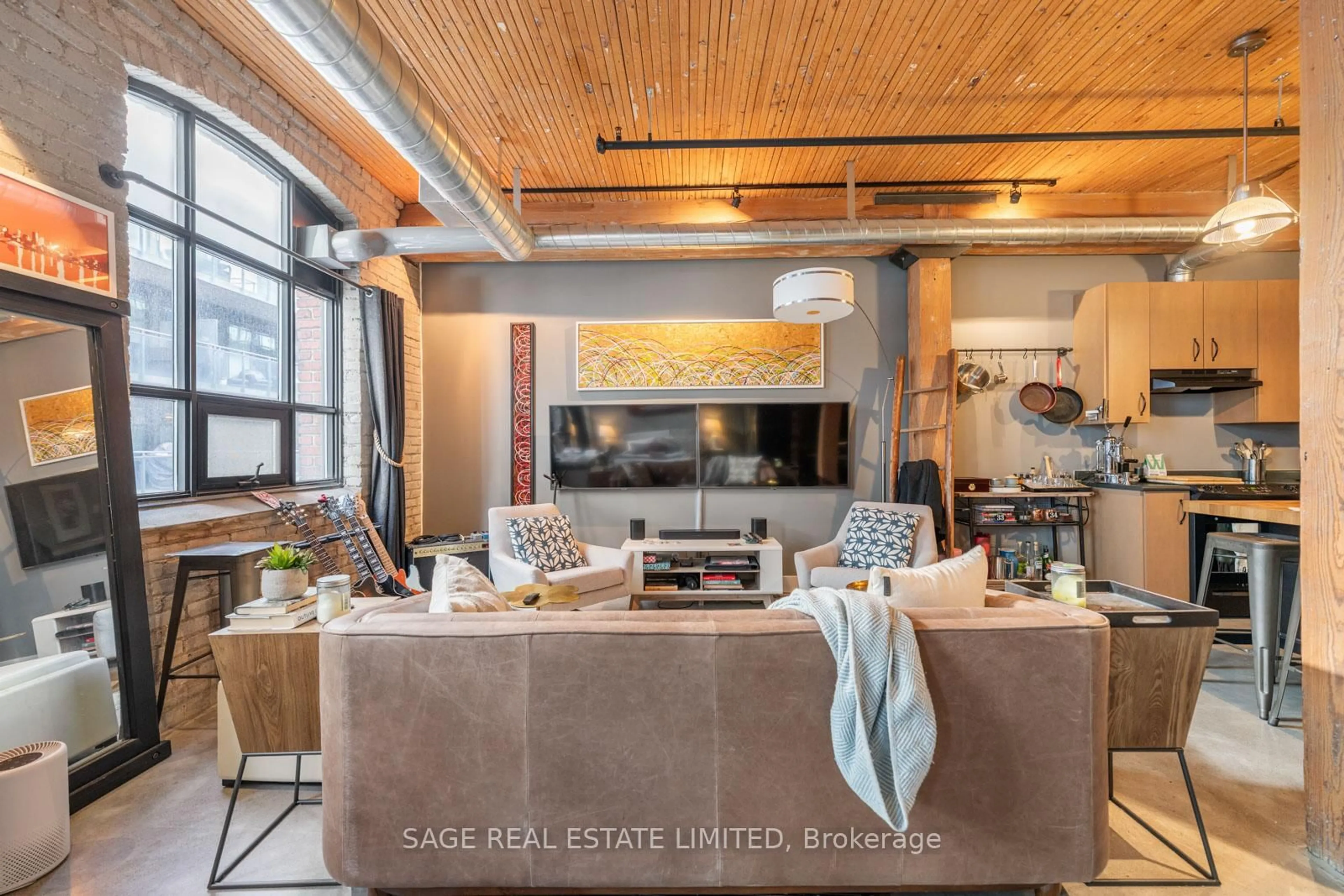 Living room with furniture, cement floor for 68 Broadview Ave #409, Toronto Ontario M4M 2E6