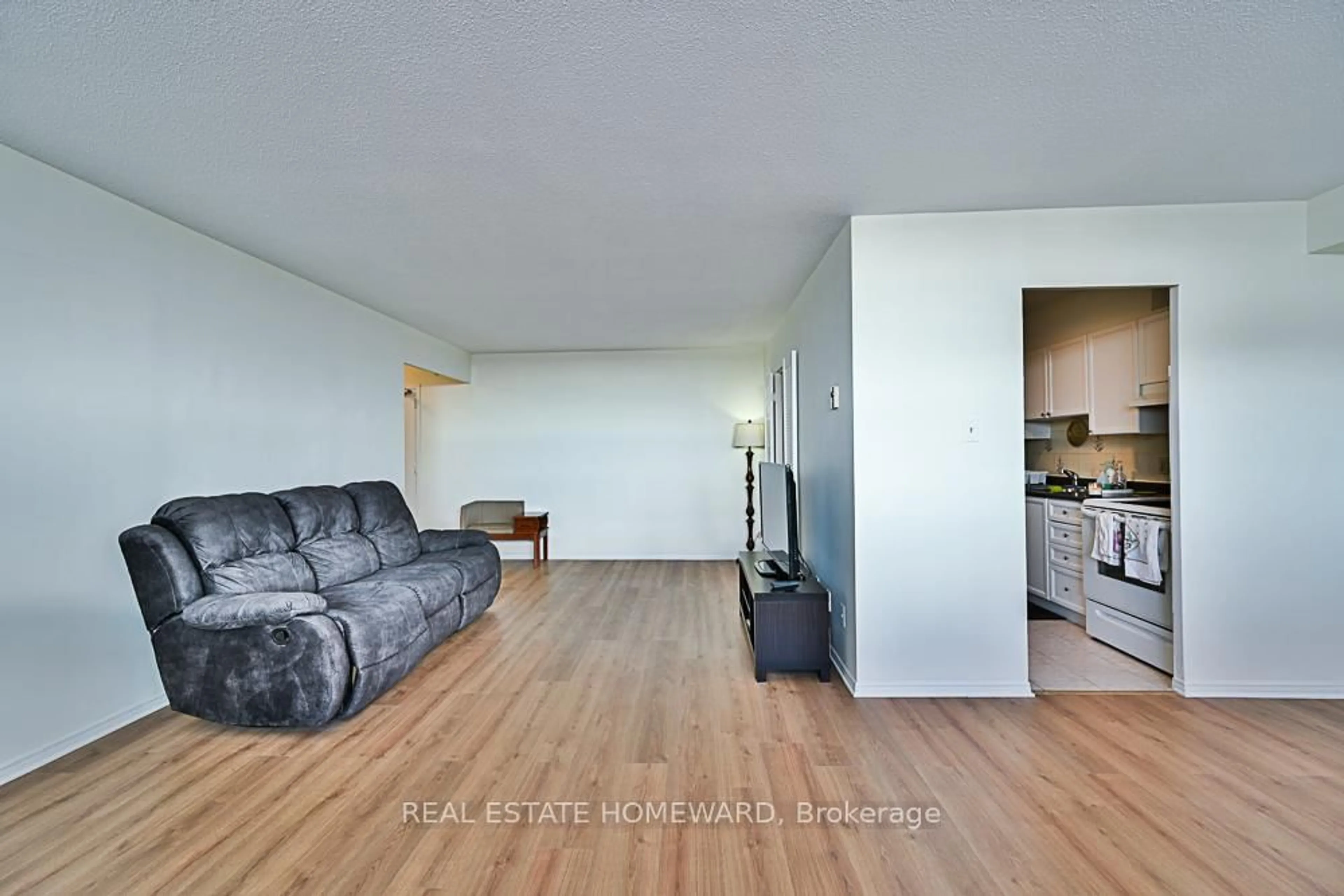 Living room with furniture, wood/laminate floor for 2550 Pharmacy Ave #1015, Toronto Ontario M1W 1H9