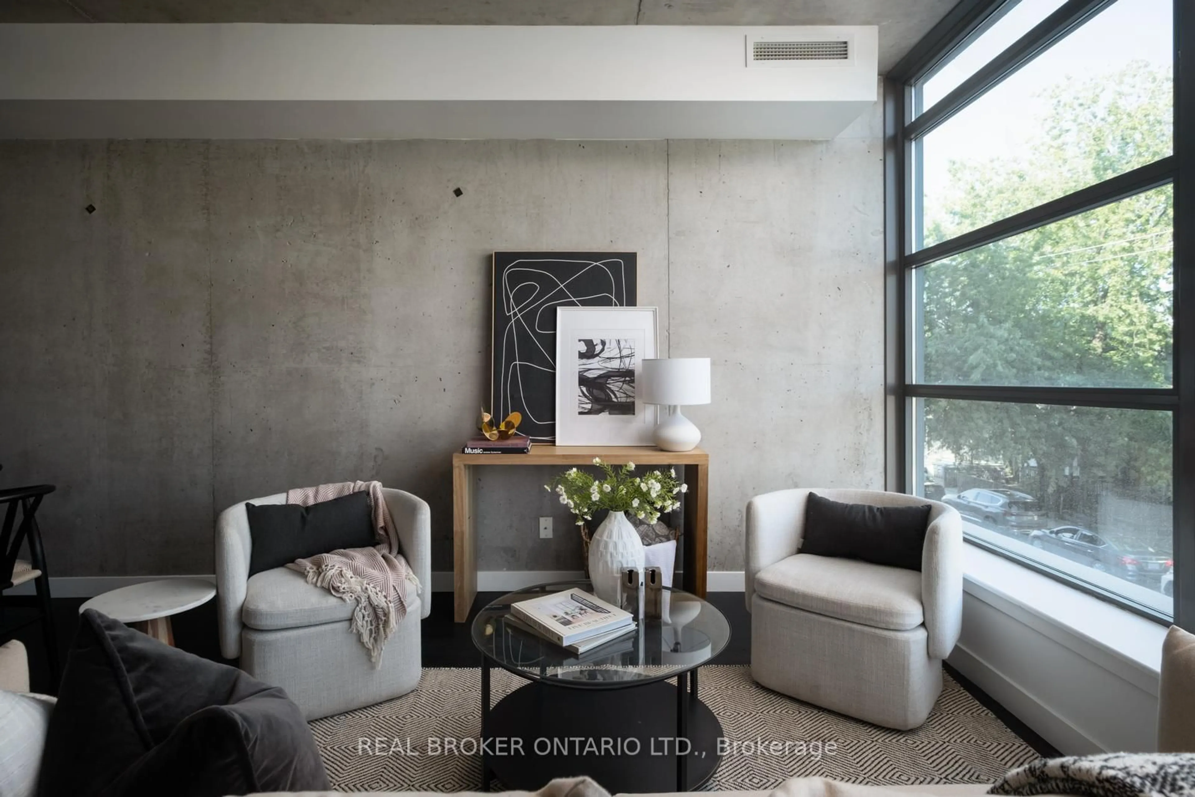 Living room with furniture, cement floor for 90 Broadview Ave #202, Toronto Ontario M4M 0A7