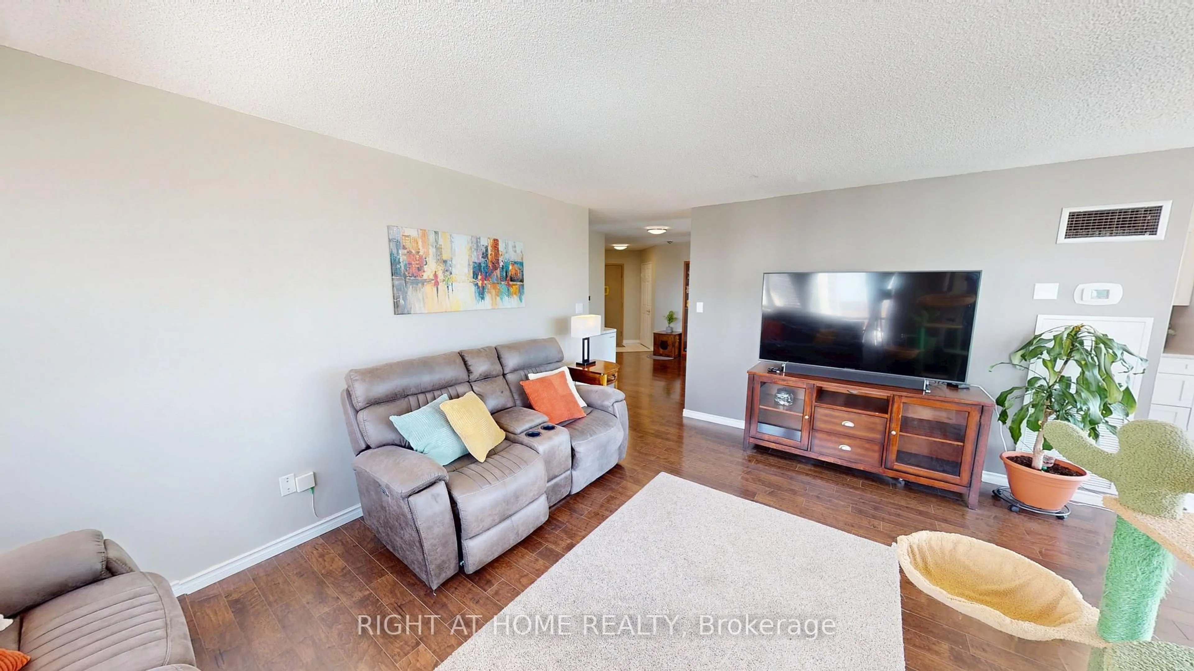 Living room with furniture, wood/laminate floor for 3231 Eglinton Ave #1206, Toronto Ontario M1J 3N5