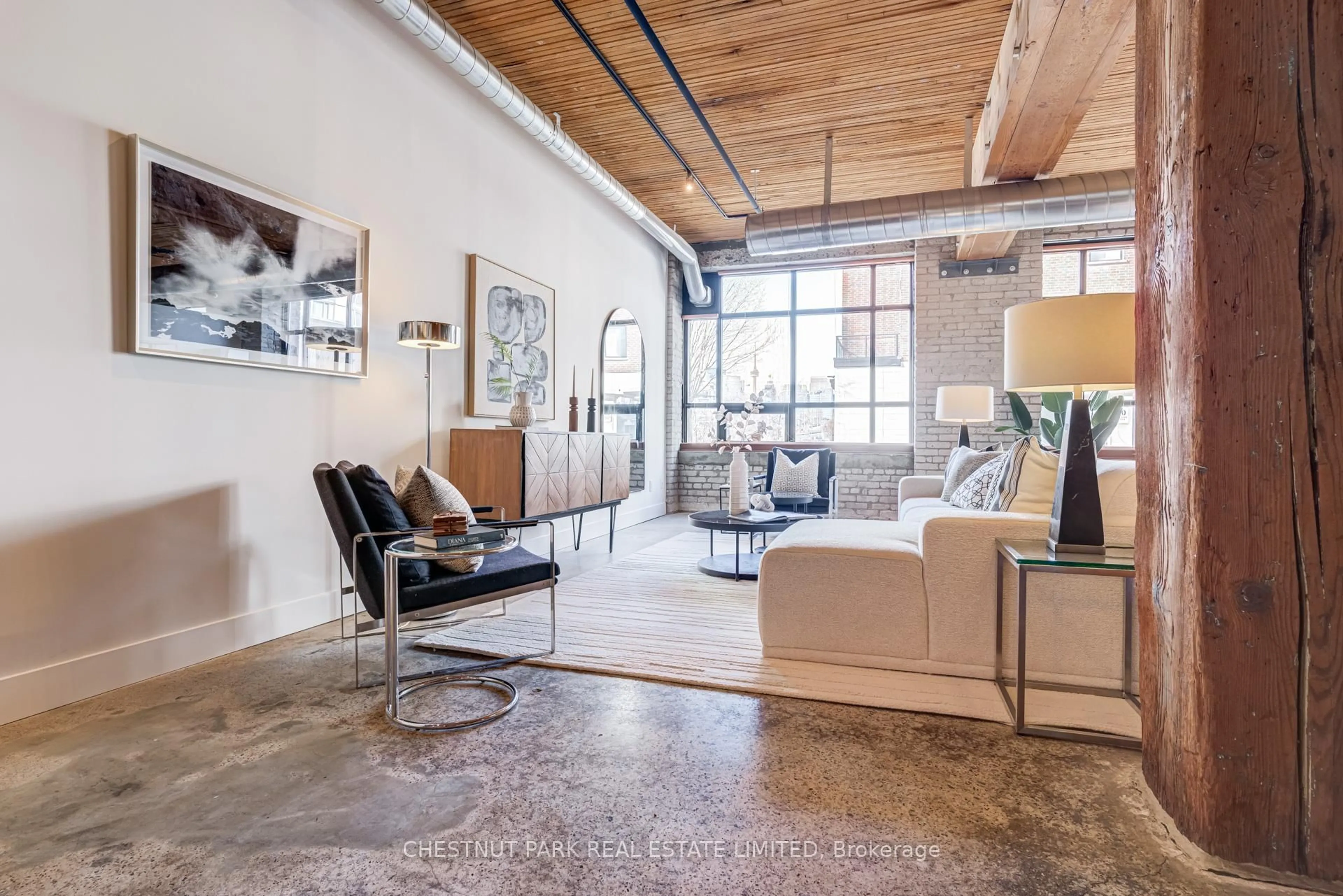 Living room with furniture, cement floor for 68 Broadview Ave #105, Toronto Ontario M4M 2E6