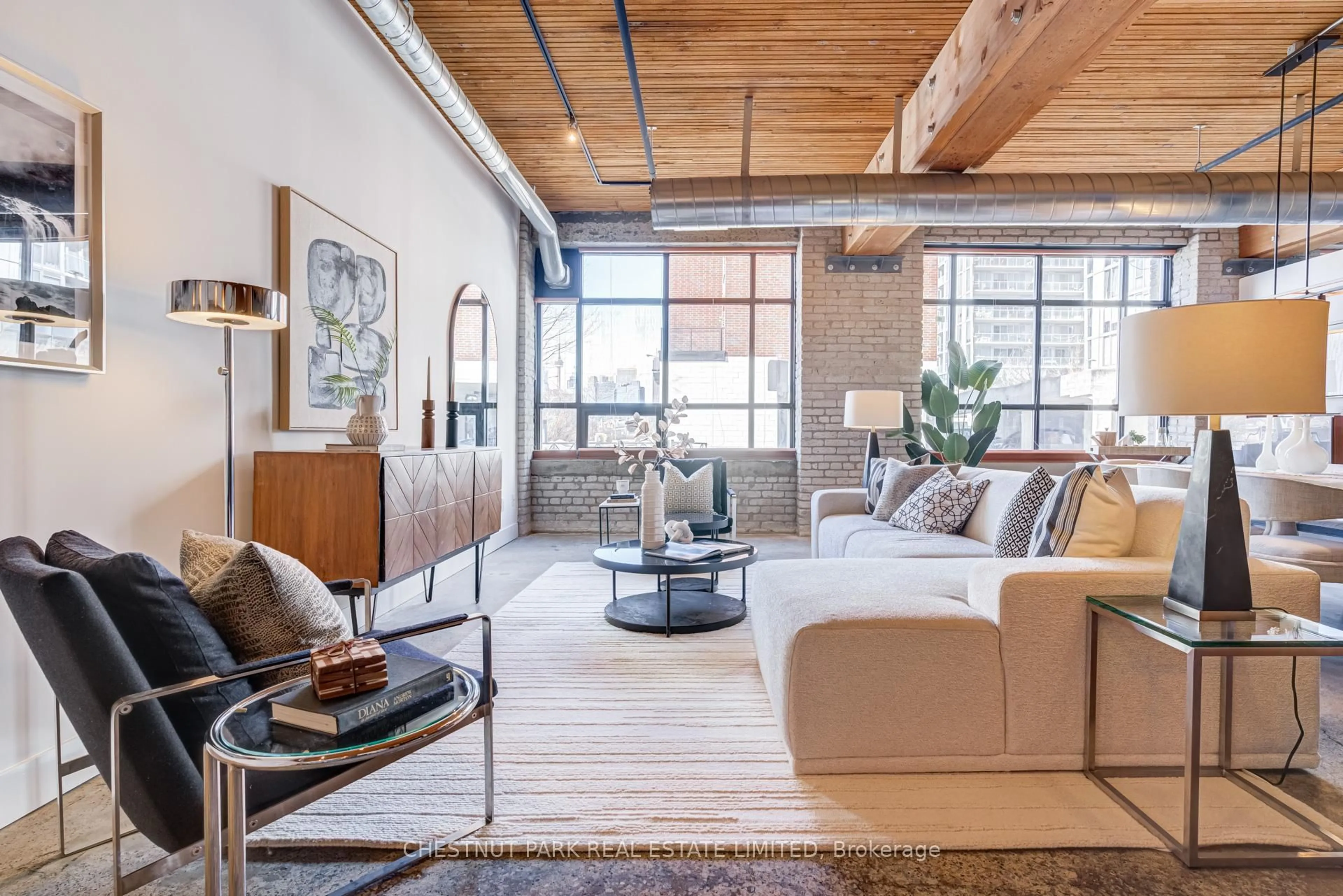 Living room with furniture, cement floor for 68 Broadview Ave #105, Toronto Ontario M4M 2E6