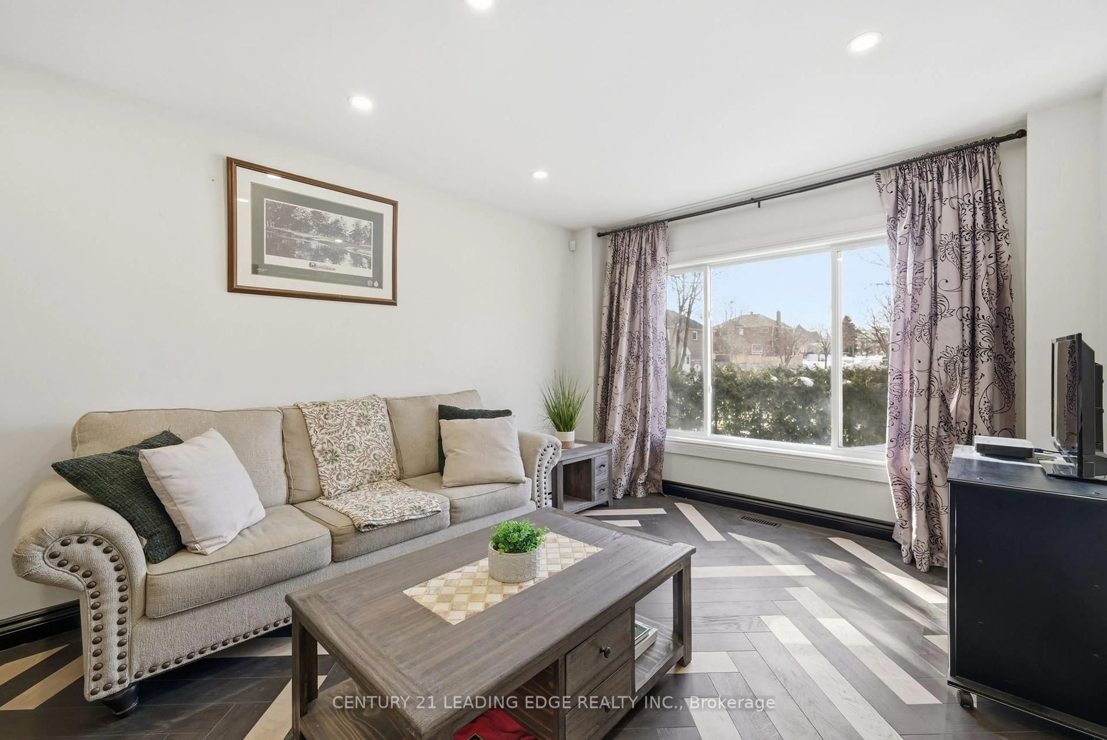 Living room with furniture, wood/laminate floor for 65 Forest Heights St, Whitby Ontario L1R 1X4