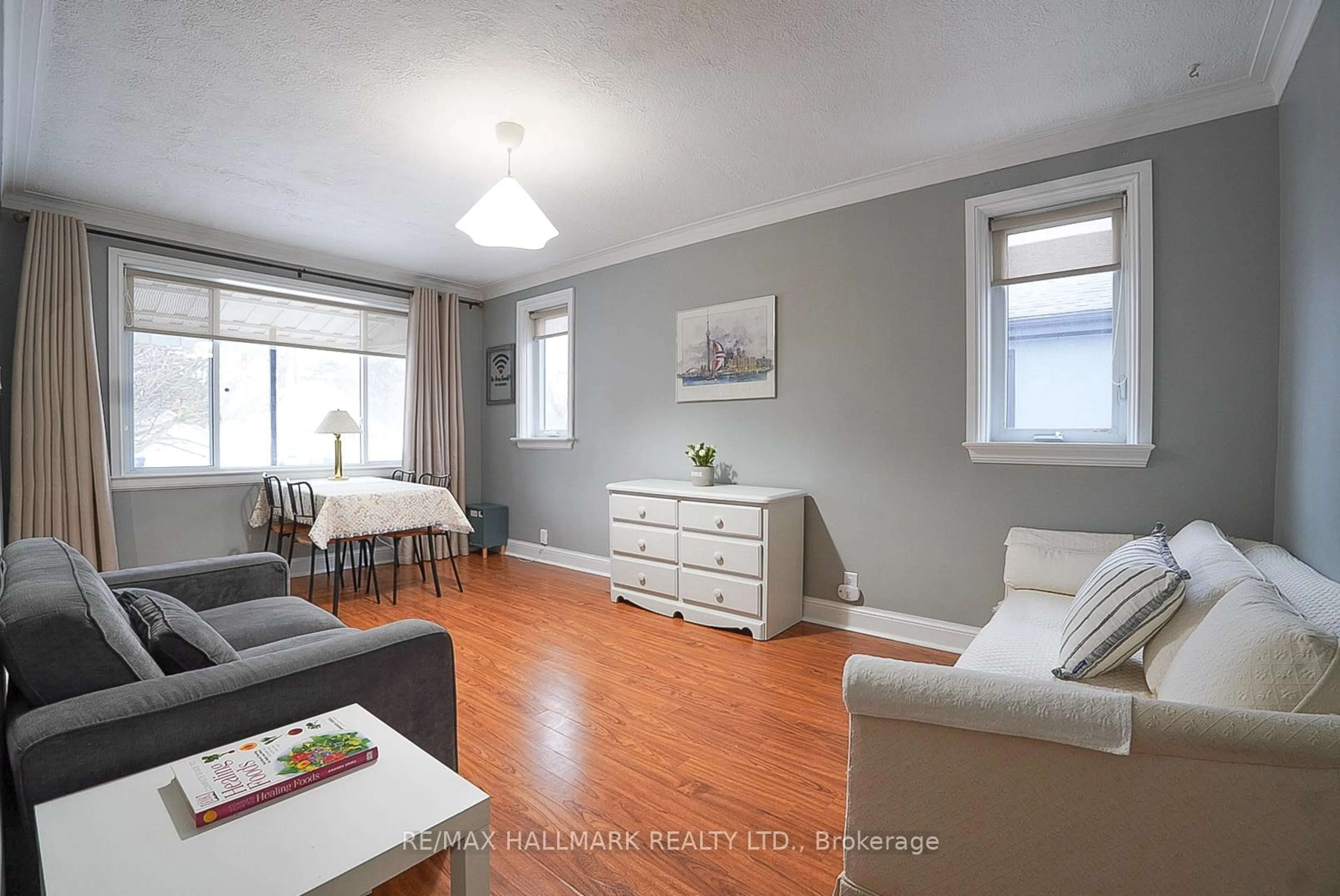 Living room with furniture, wood/laminate floor for 106 Phillip Ave, Toronto Ontario M1N 3R4