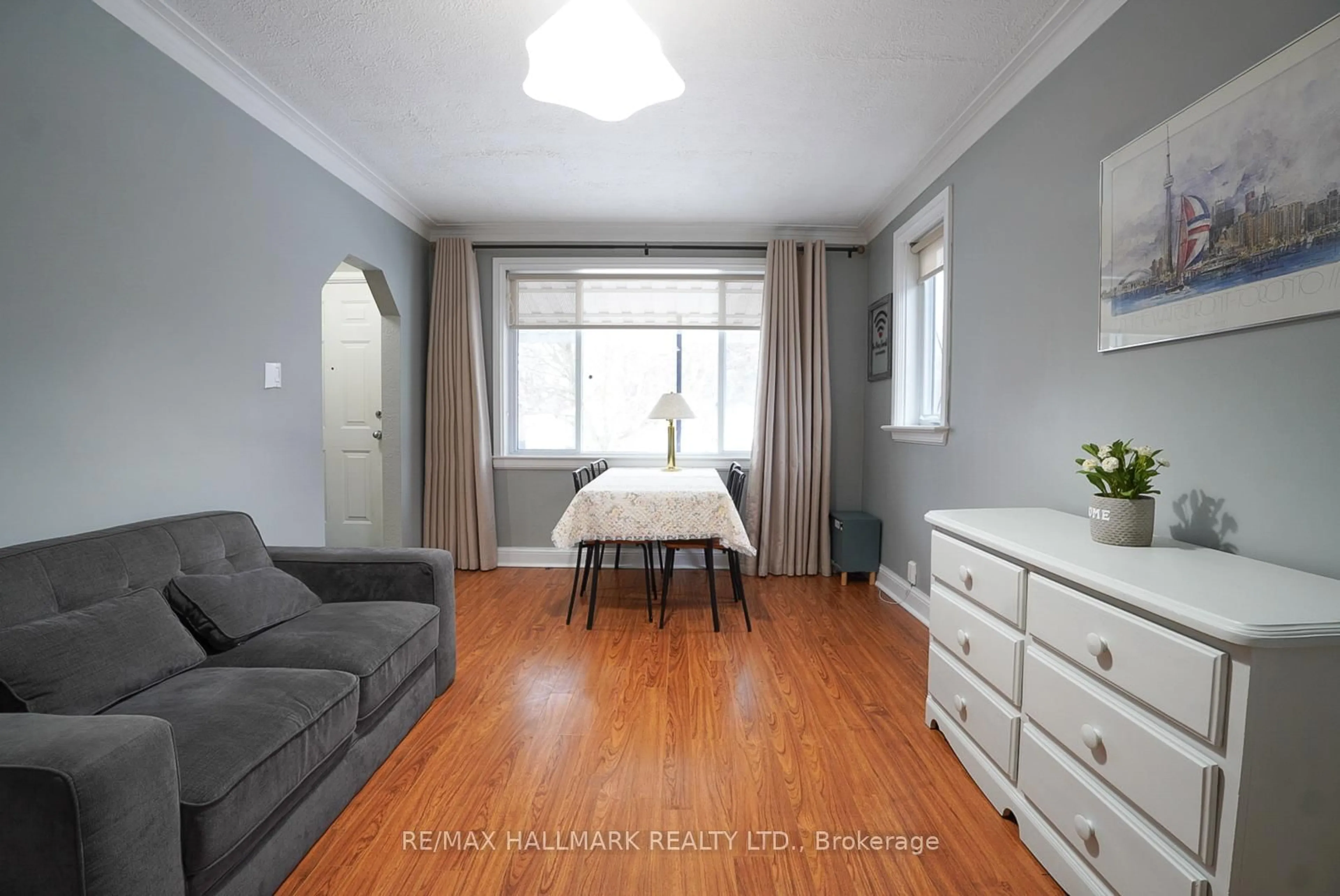 Living room with furniture, wood/laminate floor for 106 Phillip Ave, Toronto Ontario M1N 3R4