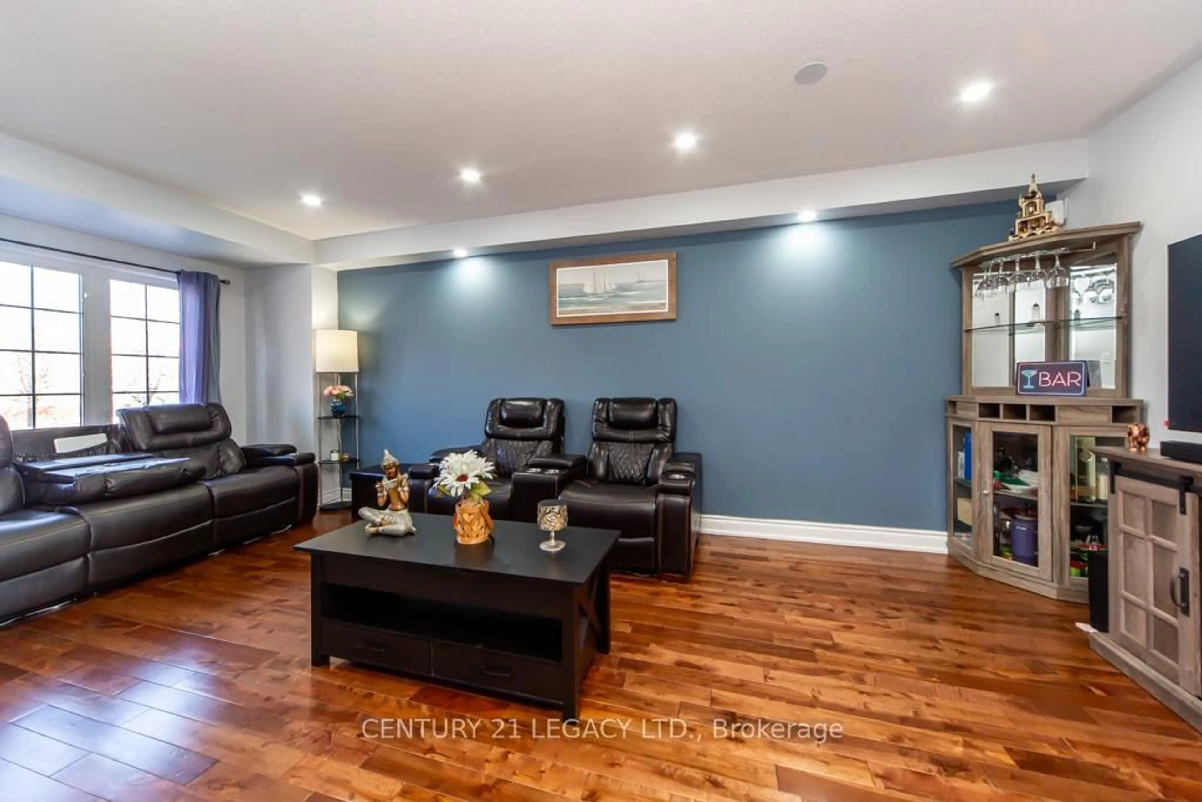 Living room with furniture, wood/laminate floor for 28 Oakins Lane, Ajax Ontario L1T 0H2