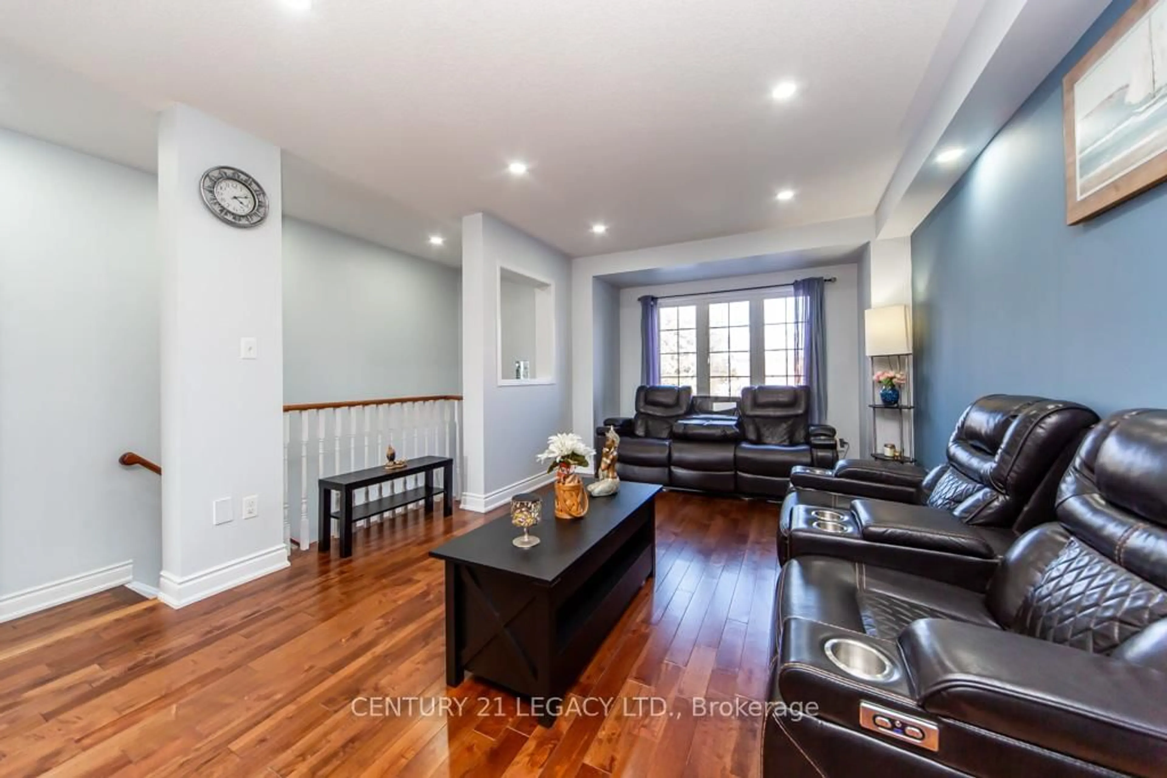 Living room with furniture, wood/laminate floor for 28 Oakins Lane, Ajax Ontario L1T 0H2