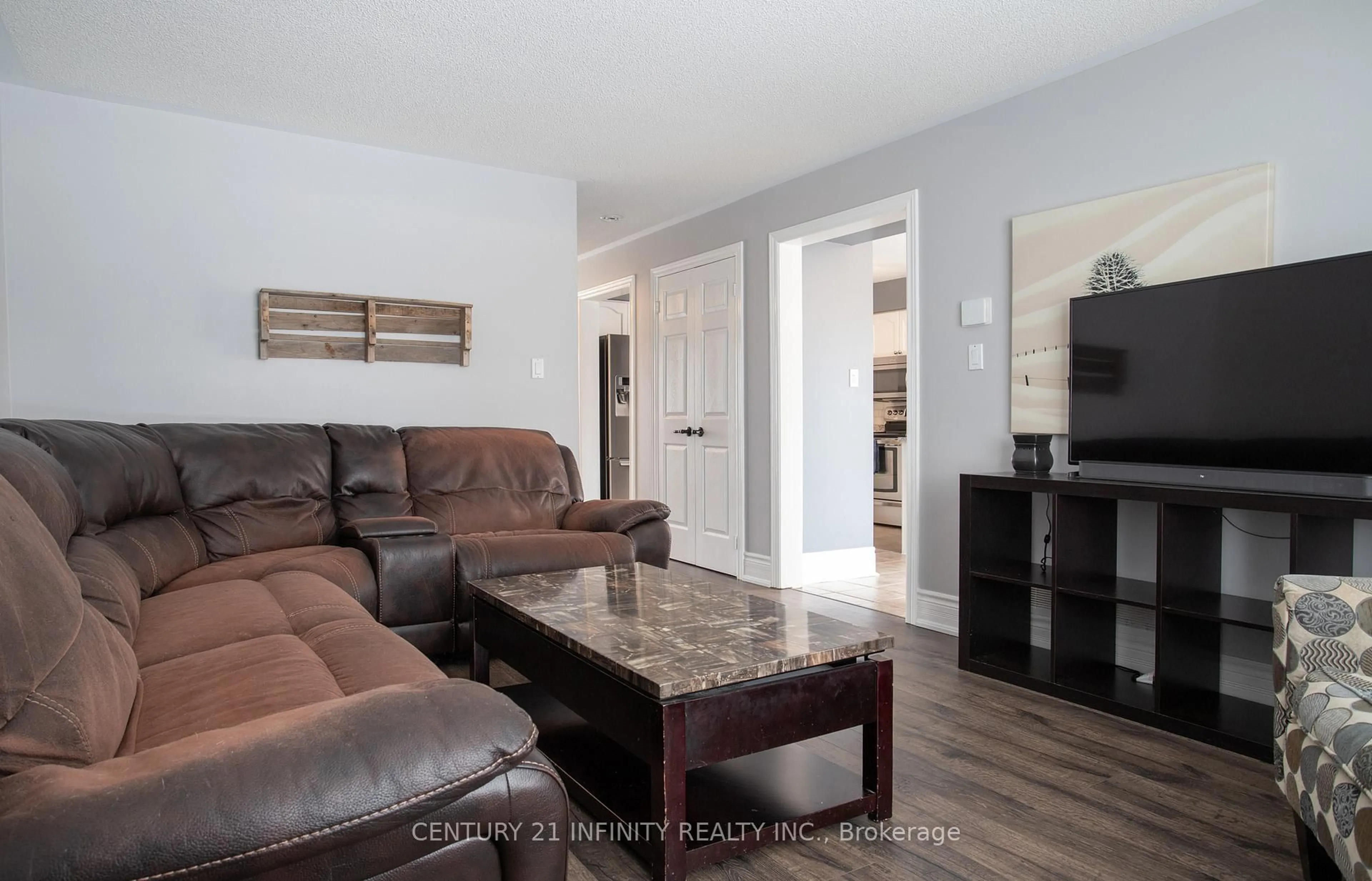 Living room with furniture, wood/laminate floor for 6 Granary Lane, Clarington Ontario L1E 2X9